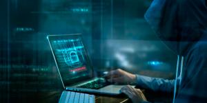 What You Need to Know About Stalkerware Person hacking a computer using Stalkerware