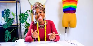 Business owner in dressmaking showroom creating a colorful dress for pride Business owner in dressmaking showroom creating a colorful dress for pride