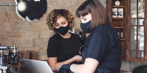 11 Cybersecurity Best Practices to Improve Business Internet Security two latina women wearing masks and working on a computer