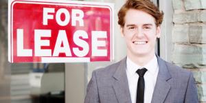 Opening Shop: Commercial Real Estate Leases man in front of for lease sign