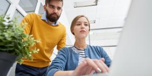 Are You a Micromanager? man looking over woman's shoulder