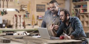 Your Most Frequently Asked Software Questions, Answered two men in woodworking studio discuss something in front of computer