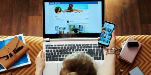 Email and Social Media Marketing that Get Results Woman checking social media on laptop and smartphone