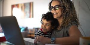 9 Tips For Starting a Digital Business as a Non-Technical Person woman sitting at laptop with a child