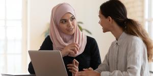 The Growing Importance of Employee Training woman in pink hijab teaching other woman at computer
