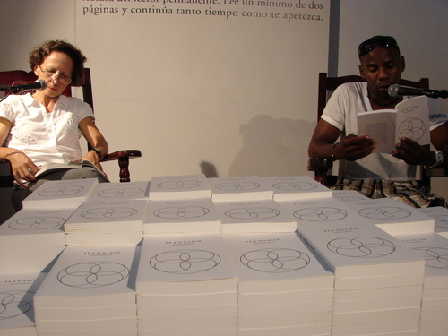 Project for 11th Havana Biennial, within the project Open Score
La Habana, Cuba 
From May 11 to June 11, 2012 
Centro Hispanoamericano de la Cultura. Malecón 17 e/ Prado y Cárcel
www.bienalhabana.cult.cu 
Illusion Reading Room is a participative installation: there is a pile of 500 copies of my novel Illusion and two armchairs. In one of them, a permanent reader is reading out loud from the novel. Public are welcome to take one copy of the novel with them for free. It is only asked to do one thing in exchange: to sit down in the vacant armchair and take it over from the reader, by reading out loud a few pages for the rest of the audience. In this way, public become part of the installation as temporary performers, and the novel is read continuously without interruption throughout the whole duration of the Biennial.  
