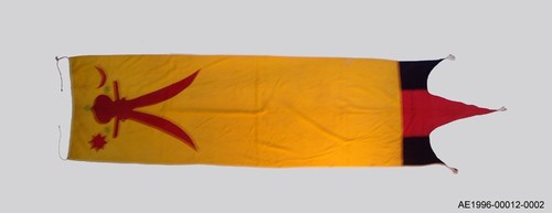 <p>If the Batak had a very different culture from the Achenese, they held good relationships with their powerful neighbours of the Sultanate. An expedition sent by the Ottoman Sultan Suleiman the Magnificent in 1565 had a profound influence on Aceh. The sword with two blades refers to the prophet Mohammed&rsquo;s sword that came into the possession of his son-in-law Caliph Ali. It is usually represented as a blade with two points, or as having two blades. The eight-pointed star is a compass rose and has special meaning in Batak tradition. The presence of three seals on the 330cm long flag confirms its royal characteristics. It is a reasonable assessment to associate this flag with Si Singamangaraja XII.</p>
