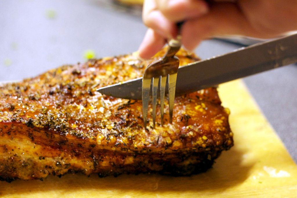 Juliette cuts the pork belly