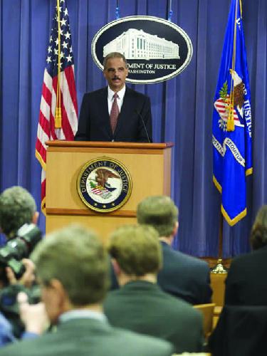 A photo of Eric Holder holding a press conference.