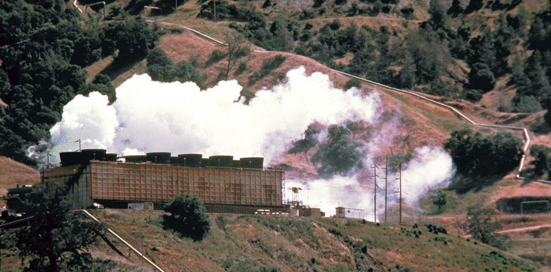 A photograph shows an energy plant on a hillside with clouds of white steam immediately above the plant