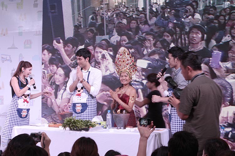 May Kaidee appearing with Thai celebrities in front of a large crowd at food festival outside Central World in Bangkok, Thailand.