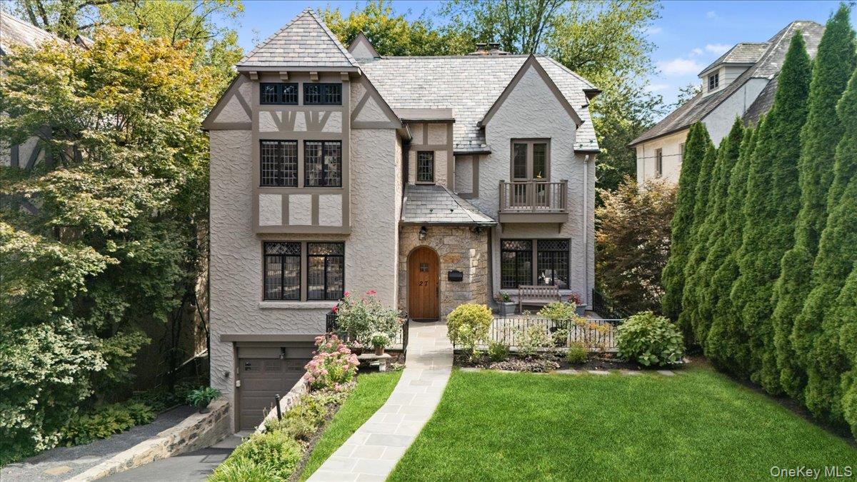 Nestled into the lush canopy of Rouken Glen hamlet, this stunning Tudor feels like a private retreat in the treetops! Live in blissful serenity high above it all, where almost every window frames a leafy green panorama and the only sound is birdsong. Beyond the glorious front terrace and manicured gardens lies a home thatâ€™s pure storybook charm with rich wood floors, latticed windows and beamed ceilings. Elegance and character pepper every space â€“ the stylish dining room, the formal living room with fireplace, the dramatic family room with soaring tray ceiling, wet-bar area and glass sliders out to a glorious deck. Alfresco entertaining here is simply magical. Steps away is the fabulous chefâ€™s kitchen with breakfast area, large pantry and adjacent powder room. Upstairs the primary suite is bright and spacious with French doors to a Juliette balcony, 3 cedar closets and an ensuite marble bathroom. This floor features two more bedrooms and a full hall bathroom. The 3rd floor offers even more space (ADDITIONAL 325sf) â€“ with a room and a full bath. Plus, thereâ€™s a wonderful walk out lower level (1, 041sf w/CO ADDITIONAL not included in total) with a spacious office that can easily accommodate multiple workstations, a full bath with versatile room originally designed as sauna, rec room, laundry, abundant storage and access to 2-car tandem garage. 27 Villa is conveniently located to Murray Ave School, close to the Leatherstocking Trail, to shops, restaurants and the train!