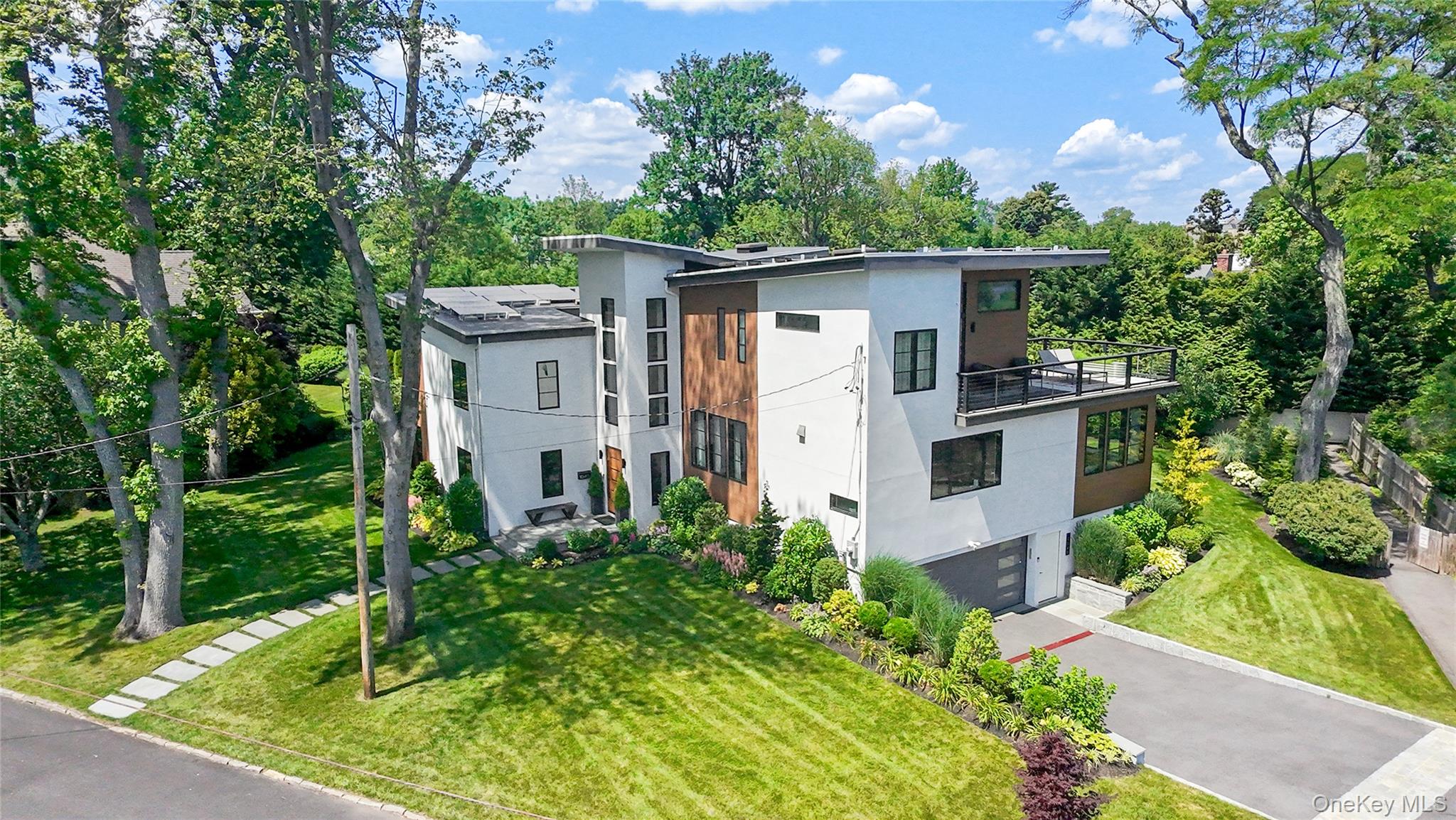 Live beautifully, by the shore. Introducing this sleek new 2021 architectural stunner with soul-soothing views of Long Island Sound and private beach access just steps away. This striking coastal retreat is peacefully positioned on large, lush .39 acre grounds at the end of a private cul-de-sac in the desirable enclave of Orienta Point - where the only sound is the gentle sea breeze! A spectacular home that channels mid-century ease with a fresh modern edge â€“ clean lines, gallery white walls and an airy open layout thatâ€™s flooded with natural light. Step inside to a soaring 2-story entry and into a fabulous kitchen and great room where views of the sparkling Sound delight. This space is laid-back luxe â€“ a waterfall center island, sunlit dining area, an idyllic sunroom or playroom - all with glass doors out to a streamlined deck for entertaining and an expansive, level lawn. The family room is stunning and offers direct access to the backyard, complemented by a light-filled office, a chic powder room, and an au pair or guest room with ensuite bath. On the 2nd-floor are three bedrooms, one with an ensuite, and two that share a full hall bath with twin vanities, plus a conveniently located laundry. Up a few steps on its own level, the primary suite lives like a private sun-drenched sanctuary with panoramic water views, a dreamy wraparound deck, exercise room or 2nd office, a resort like ensuite, and a walk-in closet to rival a designer boutique. On the lower-level is a spacious mudroom with storage and access to the 2-car garage. Modern comfort meets sustainability with a whole-house generator, solar panels, and a state-of-the-art geothermal heating and cooling systemâ€”delivering peace of mind, energy efficiency, and long-term savings. This home is peace and serenity, steps from the water, yet close to downtown Larchmont and Mamaroneck, to schools and the train to NYC! Enjoy kayaking or paddle boarding on the private beach on Nautilus Lane!