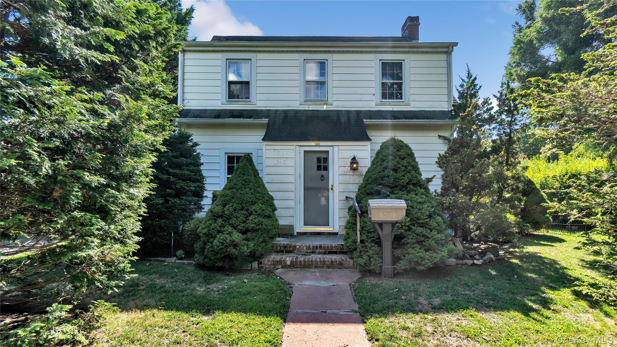 Charming 3 bedroom home with 2 full bathrooms, living room with fireplace, dining room, central air conditioning and hardwood floors throughout. full basement, detached garage. Small private well landscaped yard with covered porch. full basement, hot water heating with separate hot water heater.  Convenient location to water, Love Lane, shopping, and school.