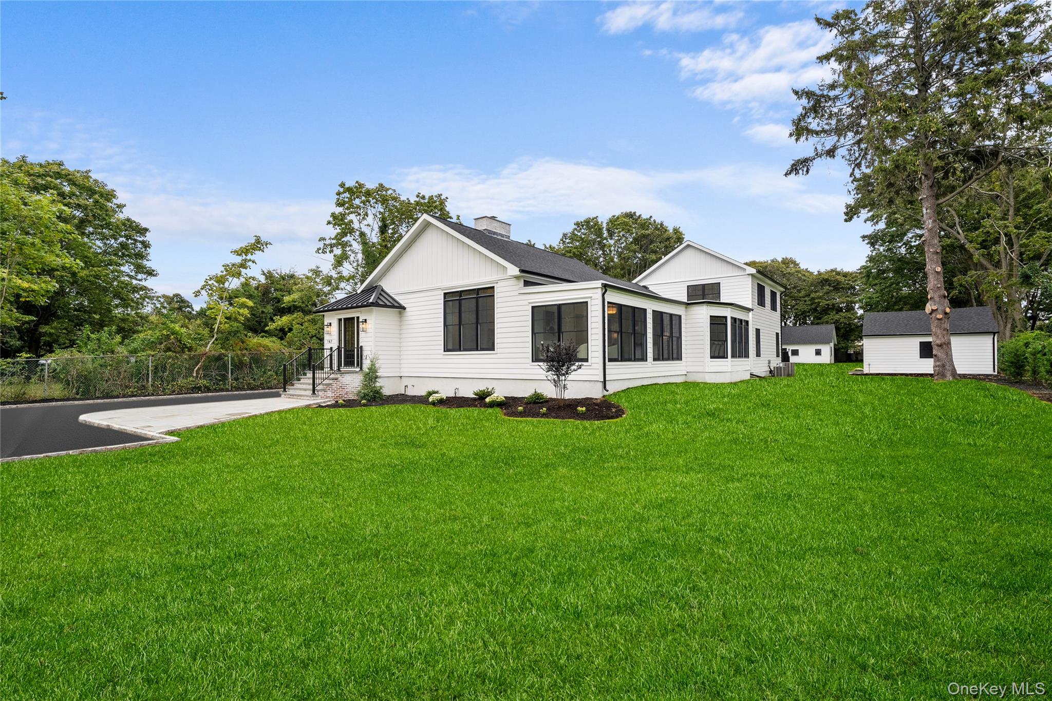 Hamptons-Inspired Luxury in South Bayportâ€™s Estate Section-Nestled on 1.1 acres in the highly sought-after estate section of South Bayport, this modern farmhouse with a charming guest cottage offers the ultimate in luxury and privacy. Rebuilt from top to bottom with no expense spared, this home caters to the most discerning buyerâ€”featuring top-tier craftsmanship, premium fixtures, and designer materials throughout. Step into the dramatic formal living room with soaring ceilings, wood beams, and an oversized fireplace that anchors the space with warmth and grandeur. Sunlight pours through expansive custom windows, enhancing the home&rsquo;s open, airy feel. A bright sunroom with coffered ceilings invites peaceful mornings and cozy afternoons. The chefâ€™s kitchen is a culinary masterpieceâ€”designed with luxurious cabinetry, a professional-grade Wolf range, and chef-level appliances. A hidden walk-in pantry with brick flooring is a delightful surprise, offering both function and charm. The formal dining room is grand in scale, ideal for entertaining with room for banquet-sized furnishings. The main level also features a spacious den for relaxed living and a serene primary en suite with designer finishes and walk in closet. Upstairs, two guest bedrooms are complemented by a tucked-away library or office spaceâ€”perfect for work or quiet reading. The guest cottage is a showstopperâ€”ideal as a home office, private guest retreat, or future pool house. Every inch of this property has been thoughtfully designed to offer exceptional living, indoors and out. Luxury, privacy, and timeless designâ€”welcome to your South Bayport dream