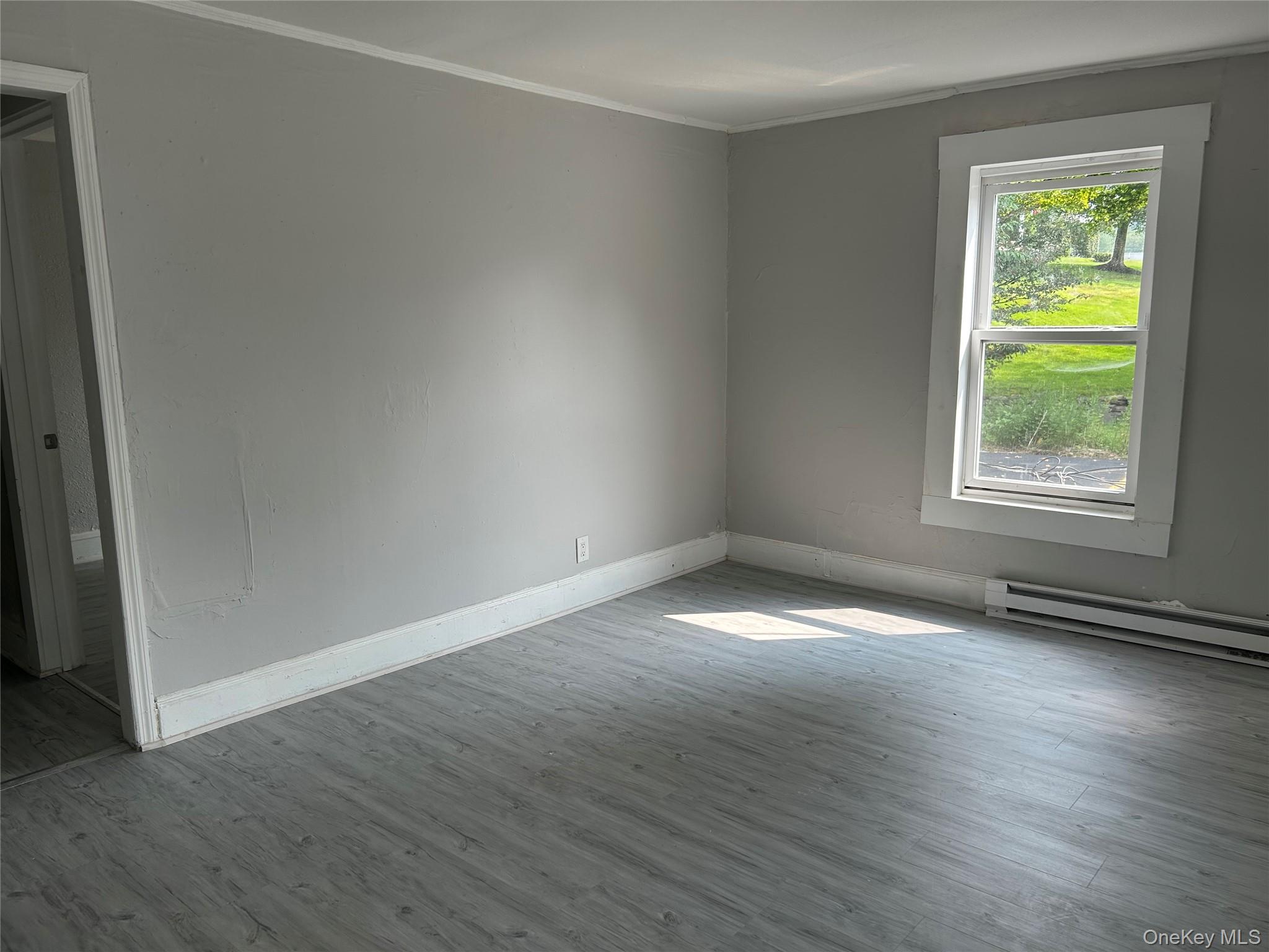Newly renovated ground-floor apartment. Lots of light. Spacious front living room. Three bedrooms, 1 full bathroom. Washer hook up. Cozy modern kitchen. Two entrances/exits- front porch and small side porch. Extra storage cove and lengthy closet, both off the main hallway. Newly paved parking spaces for tenants. Great location. Center of Woodbourne is literally right next to the Neversink River and local businesses. 15 minutes to Walmart SuperCenter, Garnet Medical Center, most Sullivan County offices, and Liberty.