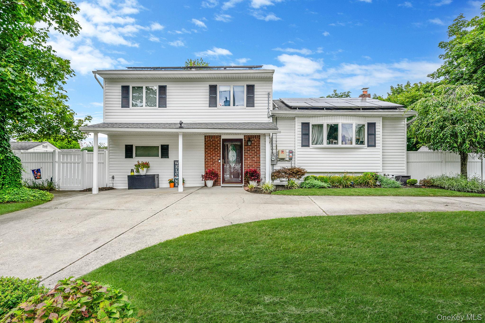Welcome to your dream home, a beautifully updated property powered by natural gas with hardwood floors throughout and plenty of natural lighting! Recent renovations completed in 2023 have transformed this residence, ensuring modern comforts with essential features such as a new hot water heater installed in 2022, a central air conditioning system added in 2024 and updated vinyl siding (2024). This home offers great potential for a mother/daughter setup (subject to proper permits), showcasing a possible inlaw suite with a separate entrance. With three spacious bedrooms, two bathrooms and an additional bonus room, flexible living spaces cater to all your needs. A full basement with laundry facilities enhances practicality, while solar panels ensure energy efficiency and low electric bills. Outside, enjoy a stunning backyard oasis complete with beautiful masonry landscaping, in ground sprinklers featuring a smart timer and permanent custom outdoor lighting. The circular driveway provides ample parking and the prime location offers convenient access to Stony Brook University, the Port Jefferson Ferry, and the Long Island Rail Road (LIRR). Donâ€™t miss this chance to make this exceptional home yours!