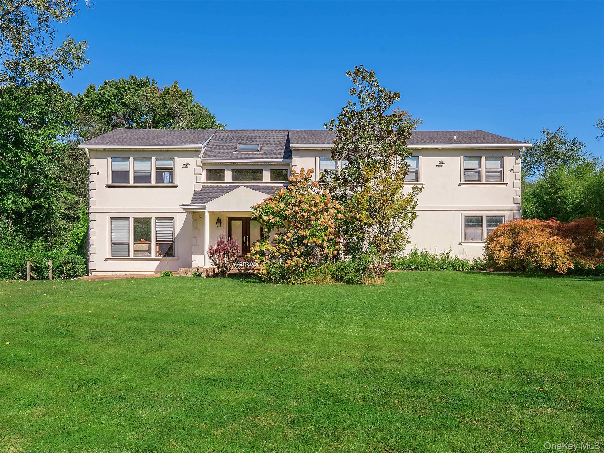 Welcome to this exquisite Center Hall Colonial located in the prestigious Village of Kings Point. Set on a beautifully landscaped flat property, this elegant home offers approximately 4, 144 square feet of refined living space, perfect for both grand-scale entertaining and everyday comfort. The main level features a dramatic entry foyer that opens to a spacious formal living room and dining room, a sunlit family room with a wood-burning fireplace, and a large modern eat-in kitchen with center island, granite countertops, and breakfast area with sliding doors leading to an oversized deck and expansive backyard. A private guest bedroom or office with full bath, powder room, spacious mudroom, and a dedicated laundry room complete the main floor. Upstairs, the luxurious primary suite offers a vaulted ceiling, spa-like marble bathroom, and walk-in closet. Three additional well-appointed bedrooms and one full bath provide comfort and privacy. The spacious finished basement includes a large playroom utility room, storage, with walk-out access to the yard. Outdoors, enjoy a private country club lifestyle with a sparkling in-ground swimming pool, oversized new deck, and plenty of space for entertaining. Additional features include an attached two-car garage, hardwood floors on main level, central air conditioning, and a two-zone gas heating and cooling system. Ideally located close to town, shops, restaurants, railroad, and fabulous park district, this is a rare opportunity to own a timeless and elegant home in one of Long Islandâ€™s most exclusive communities.