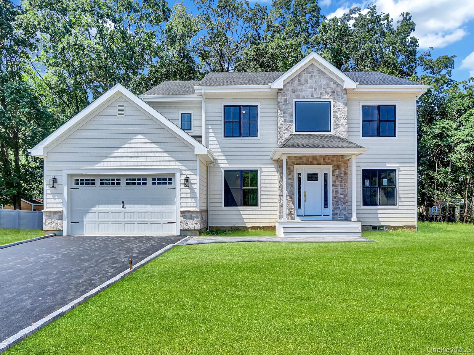 This is a rare opportunity to own new construction in Setauket, featuring a 2891 square foot custom Colonial set on a quiet cul de sac on a .75 acre lot. The exterior includes cedar style shake siding, white trim, partial stone facade, Andersen windows, a solar ready architectural roof, covered front portico, and a two car garage with opener and awning windows. Inside, the home offers a grand two story entry, hardwood floors, recessed lighting, custom moldings, and nine foot ceilings on the first floor. The open layout includes a chefs kitchen with stainless steel appliances, shaker cabinetry, quartz countertops, a center island with seating, pantry, mudroom, powder room, and access to the garage. The kitchen flows into a spacious great room with a gas fireplace, alongside a formal dining room and formal living room. Upstairs, the primary suite features a walk in closet and spa inspired bath with double sinks, while three additional bedrooms with large closets share a full hall bath with double sinks. The second floor also includes a laundry room with washer and dryer. Additional features are a full basement with eight foot ceilings, natural gas heat, two zone central air, and a 50 gallon hot water heater. Built by Kelly Development, an experienced Long Island builder with more than 30 years in the industry, the home comes with turnkey construction, pre move in cleaning, a new home orientation, and a comprehensive warranty. To be Built.