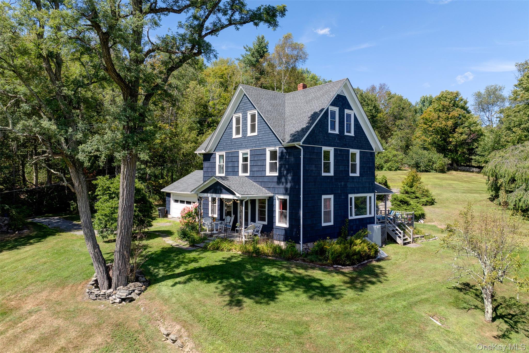 Set on more than 36 acres along one of the most coveted country roads in the area, this classic three-story farmhouse offers a perfect blend of spacious rural charm and expansive outdoor living. Built in 1908, the home is framed by lush lawns dotted with fruit trees and anchored by a serene swimming pond with dock. Inside, the layout centers around a retro-vibe kitchen with dining alcove crowned by an arch and bathed in sunlight. The kitchen offers access to the back deck with its refreshing outdoor shower and grounds beyond. A wood-paneled dining room invites festive gatherings, while the living roomâ€™s fireplace and vinyl-record ambiance recall lazy, fireside evenings. A breezeway lined with windows connects the house to the garage, adding to the homeâ€™s understated grace. Upstairs, the generous primary suite is a sanctuary, complemented by two additional bedrooms and a full bath. The finished attic expands the footprint with four versatile roomsâ€”ideal for home offices, guest quarters, or creative space. The grounds are a birdwatcherâ€™s paradise, alive with species like orioles, hawks, and warblers. Thereâ€™s even a scenic old stone foundation, begging to be transformed into a dream outdoor focal point. Centrally situated, the property places you minutes from Callicoon Hills restaurant, shops in Jeffersonville and Roscoe, and a short drive to Callicoon and Livingston Manor.