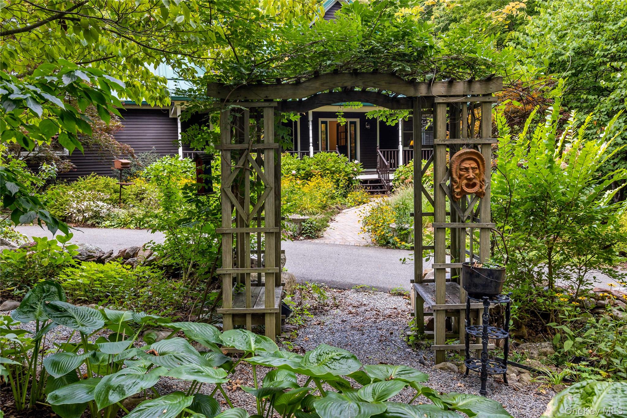 Private Bucolic Retreat â€“ Where Modern Elegance Meets Timeless Country SerenityTucked away on nearly 2 pristine acres in Cold Spring, this custom-built colonial offers the rare opportunity: seclusion and accessibility. Surrounded by gardens designed and curated by a Certified Master Gardener, the property is a living work of artâ€”lush with seasonal blooms, shaded woodland paths, and landscapes that shift gracefully with the turning of each season. Sip your morning coffee on the welcoming front porch as the sun crests the treetops, listen to the quiet hum of nature, and watch the gardens awaken in color and light. In the evenings, the back deck becomes the perfect gathering place for friends and familyâ€”where sunsets spill across the horizon, laughter lingers, and every view feels like a painting. The kitchen is a true centerpieceâ€”anchored by a large center island, dressed in quartz countertops, and outfitted with stainless steel appliances, including a professional 6-burner gas range. A custom dining nook provides an intimate space for everyday meals, overlooking the gardens outside, while the kitchen flows effortlessly into the sunlit great room. Here, soaring cathedral ceilings, skylights, expansive custom windows, and French doors blur the lines between indoors and outdoors, filling the space with warmth, light, and views of the manicured grounds. The main-level primary suite is designed as a private sanctuary. With its spa-inspired bath, walk-in closet, and French doors that lead directly to the deck, it offers the perfect blend of indulgence and comfort. This level also includes a versatile denâ€”ideal as a study, reading room, or creative spaceâ€”along with a full bath, mudroom with direct yard access, laundry room, and an oversized 2-car garage with abundant storage. The second floor offers two generously sized bedrooms, a full bath, and a second family room with vaulted ceilings - perfect for relaxation, movie nights, or gaming. A full walk-out basement, currently unfinished, offers nearly unlimited potentialâ€”whether envisioned as a fitness suite, home theater, wine cellar, workshop, or additional living quarters. Outside, the property is nothing short of enchanting. Created and nurtured by a Certified Master Gardener, the grounds are a year-round display of thoughtful design and natural splendor. Meandering trails invite exploration, curated plantings frame every view, and gardens bloom in rich succession from spring to fall. There are quiet wooded corners for reflection, open lawns for play, and vibrant garden beds that bring life and color to every season. From the welcoming front porch to the expansive rear deck, each outdoor space invites you to slow down, savor the moment, and gather with those you love. This is a home where outdoor living feels as natural and compelling as the indoors. Every detail of the home has been chosen for both beauty and longevity. Cedar siding, a standing-seam metal roof, central air, hardwood floors throughout, and a whole-house generator ensure not only everyday comfort but also confidence in the homeâ€™s enduring quality. Less than 9 minutes from Metro-North, the Taconic Parkway, and I-84, the location is both convenient and inspiring. Hiking trails, biking routes, golf courses, and the cultural richness of the Hudson River towns are all nearby. Cold Spring itself is a beloved destinationâ€”offering historic charm, eclectic shops, farm-to-table dining, and riverfront views that captivate visitors and residents alike. Here, you can spend your mornings on woodland trails, your afternoons exploring charming villages, and your evenings watching the stars from your own private deck. All while knowing that the energy of New York City is less than an hour away. This home is more than a residenceâ€”it is a retreat, a lifestyle, and a rare opportunity to experience the very best of country living with every modern convenience at your fingertips.