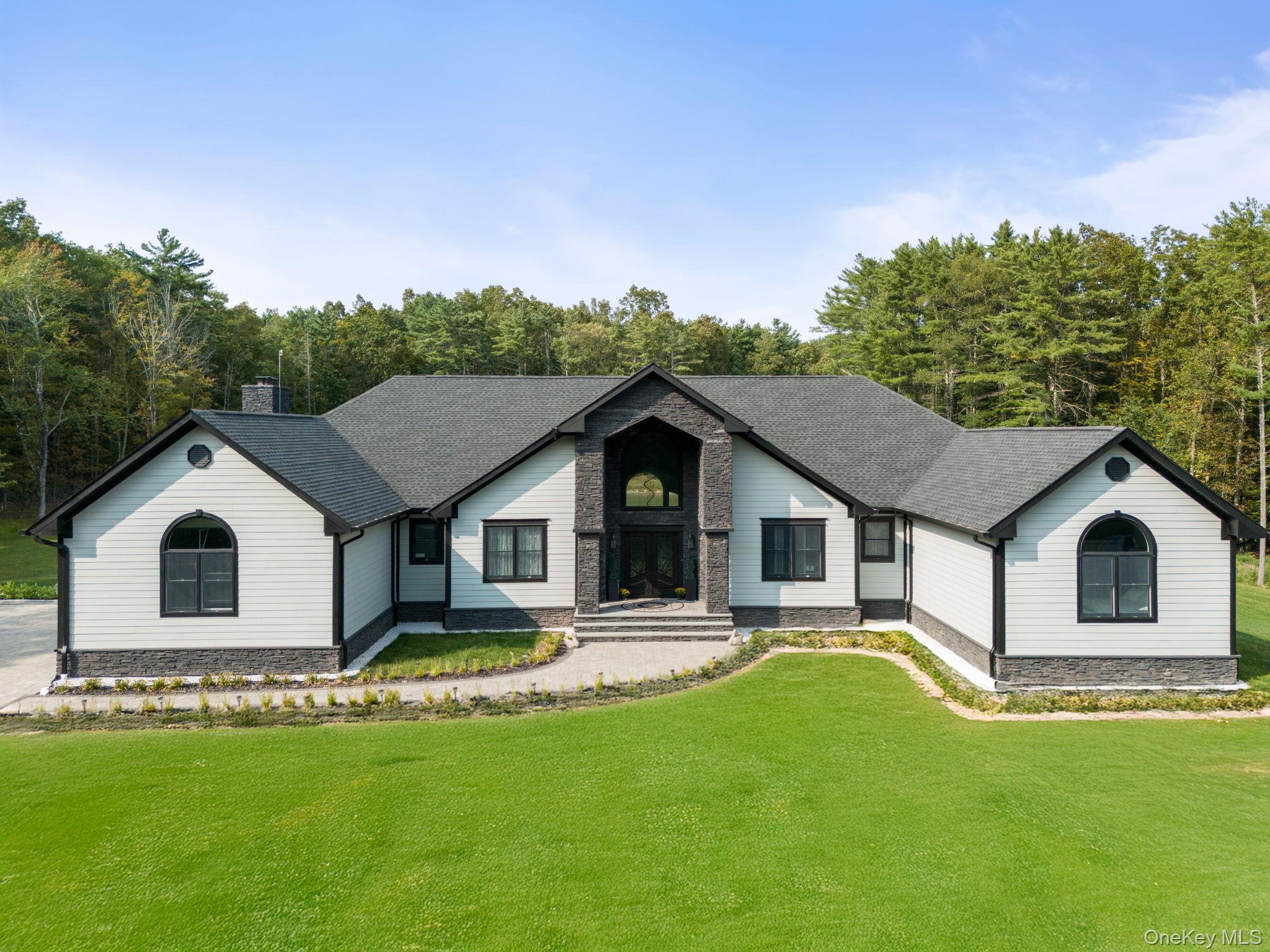 Experience refined living at this 4-year-young luxury estate in Coxsackie, NY. Offering the ease of one-level living, this home spans nearly 7, 200 sq ft, including 3, 400 sq ft of beautifully finished walkout basement. Set on 14 private acres, the residence showcases 4 bedrooms, 3.5 baths, a private office, and a 4-car garage, blending sophistication, comfort, and modern design. Soaring ceilings, walls of glass, and sun-drenched interiors frame sweeping views of the surrounding landscape, creating an atmosphere of elegance and light. The gourmet kitchen is a chefâ€™s dream, complemented by a serene primary suite and generously sized bedrooms. The lower level extends the living space with a private bedroom and full bath â€” ideal for guests, a nanny, or an in-law suite. Additional appointments include a whole house generator and a fiberglass deck that fully covers the patio, seamlessly connecting indoor and outdoor living. The grounds are a private sanctuary, showcasing a picturesque koi-filled pond, manicured acreage, and ample space for recreation or quiet retreat. Perfectly positioned near a premier golf course, the Hudson River, charming villages, and with seamless access to the NYS Thruway, this estate offers both exclusivity and convenience. A rare opportunity to acquire a sophisticated Hudson Valley retreat designed for luxurious one-level living and effortless entertaining.