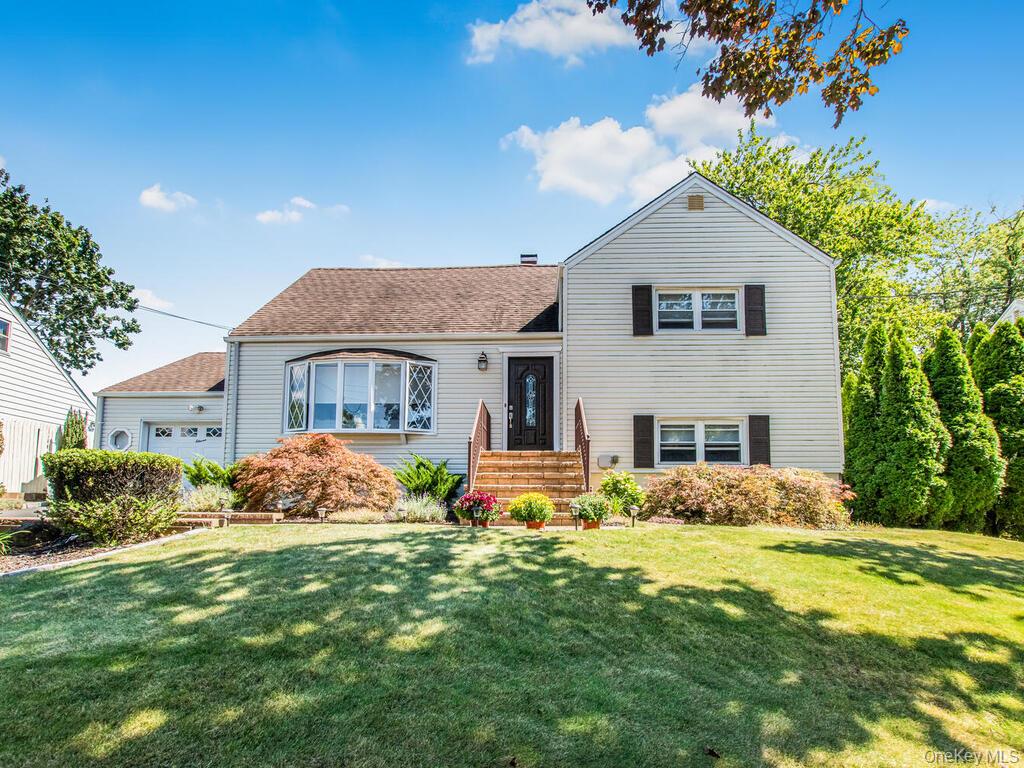 Welcome to this spectacular split level gem set above the road on gorgeous property featuring stunning wall to wall interior design . Main living level offers easy flow from large living room to eat-in kitchen and formal dining room. Bow window provides great natural light to this entire space. Eat-in kitchen features caramel cabinets, stone counters, gas range, stainless appliances, counter seating and views of the private backyard oasis. Formal dining room with glass sliders offers easy access to rear yard and deck. Two bedrooms and stunning bright white bath with soaker tub on second level. Private, spacious primary suite on upper level offers quaint vanity area and en-suite bath with soaker tub. Walk-in lower level offers large family room/recreation room, laundry closet, full bath, storage and access to rear patio area. Carefully designed expansive open air deck allows for several conversation areas perfect for large gatherings. Mature trees and perennial blooms surround front and rear gardens offering privacy and a beautiful natural landscape. One car attached garage with additional storage space. Amenities include family room, central air, hardwood floors, crown molding, attached garage, fenced yard, sprinkler system, alarm system, updated plumbing and electric. Nearby: Sprain Lake Golf Course and Grill, Central Park Avenue shops, Ridge Hill Plaza, local transportation, Manhattan Express bus, school, and many local restaurants.