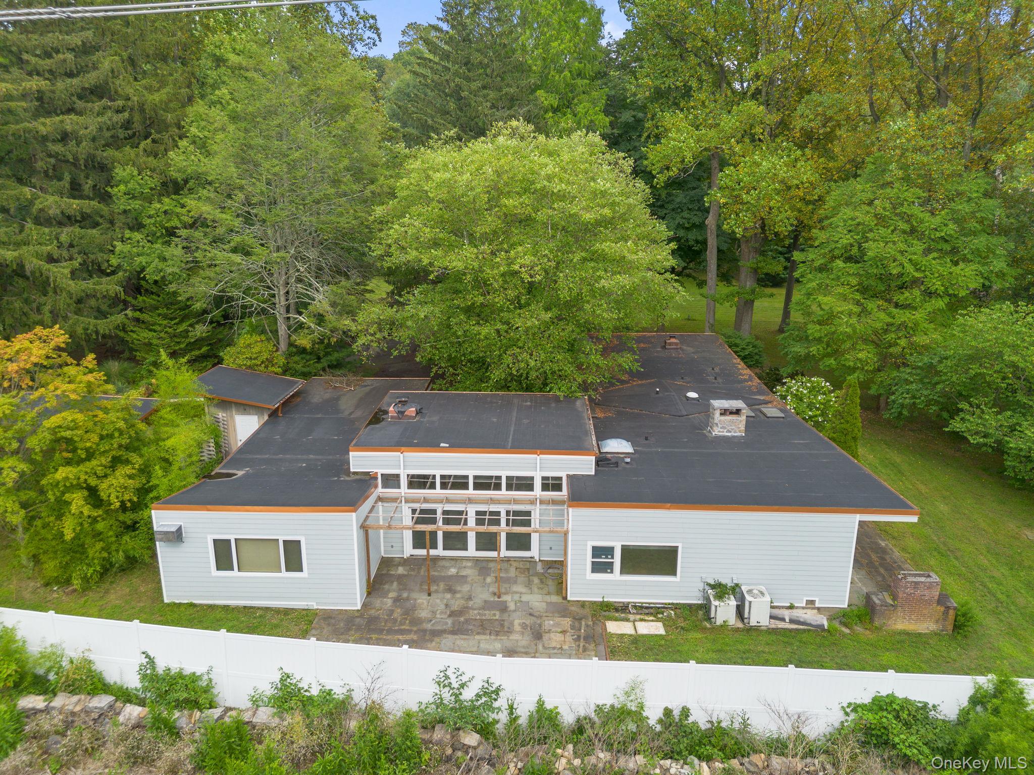 Welcome to this expansive 6-bedroom, 5-bath mid-century ranch on nearly 1.6 private acres in the heart of Hartsdale. Offering over 4, 000 sq. ft. of living space, this home features an open layout with high ceilings, multiple fireplaces, hardwood floors, and a sun-drenched enclosed porch. The open kitchen and spacious family room make entertaining easy, while the primary suite and additional bedrooms provide comfort and privacy for everyone. Step outside to enjoy the in-ground pool, deck, and mature landscaped grounds with direct golf course views. A 2-car attached garage, ample driveway parking, and proximity to shops, parks, Greenburgh pool/tennis, and the Hartsdale Metro North station make this property as convenient as it is serene. An exceptional rental opportunity in a sought-after neighborhood.