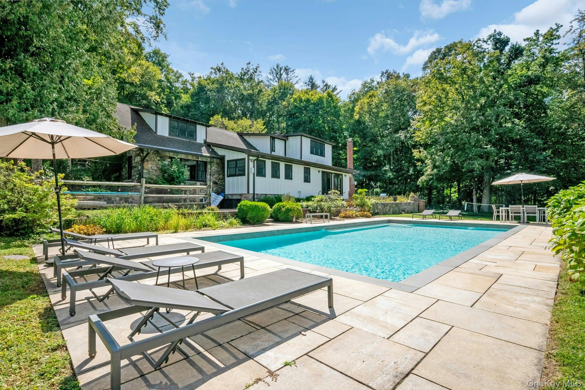An extraordinary compound just minutes from downtown Katonah this 4.1-acre estate is comprised of a fully renovated 4 bedroom stone farmhouse, a guest cottage, 2 car garage plus 3rd bay, a storage barn, pool and beautiful expansive property with winter reservoir views. The main residence offers light-filled interiors, custom millwork, a gourmet chefâ€™s kitchen, renovated spa-inspired bathrooms, designer finishes and a seamless flow designed for todayâ€™s lifestyle. The property lives like a private resort with a sparkling pool framed by open lawns, stone patio, firepit area, mature trees while multiple outbuildings creating unmatched versatility. A 720 SF cottage (not included in the SF) provides options for multigenerational living, a work from home retreat or rental income. Offering rare privacy without sacrificing convenience, this exceptional estate is moments from Katonah village, shopping, and direct train service to Manhattan - an ideal balance of refined country living and modern luxury.
