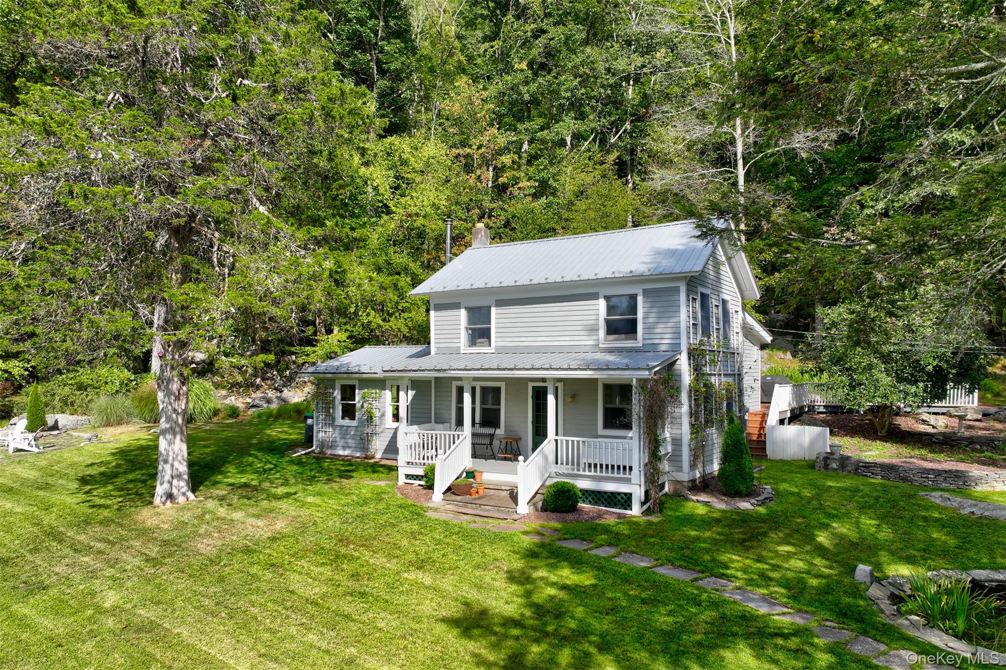 From the front porch of this c.1900 farmhouse, the soundtrack of the Lackawaxen River drifts clearly through the airâ€”a constant, calming presence that mingles with birdsong and breeze. Perched on a gentle rise, the home looks out across sweeping views of the river and rolling hills, a seasonally changing canvas of light and color. â€¢The approach is a study in country charm: perennial gardens weave among natural rock formations, creating pockets of beauty that invite pauseâ€”quiet corners for morning coffee, a book, or conversation with friends. A stone patio and rocking-chair porch offer front-row seats to the eagles foraging over the water. â€¢Inside, the home retains its character from the early century with wainscoting, chair rails, and built-ins. The thoroughly modern kitchen is at the heart of the house, finished with slate counters, tile backsplash, and stainless steel appliances. â€¢On one side of the home, a dining area opens for either quotidian or celebratory meals. There is also a corner sitting area with South and West light incoming, and the perennial sounds of the river. On the other side, the living space centers around a wood stove and a built-in reading nook with an uber cozy daybed. A fully renovated full bath is opposite the kitchen, which features a tiled, walk-in shower with a glass door, and laundry cleverly hidden behind a shade. â€¢Two staircases lead to the bedrooms above. Guest rooms, bright with views of the river, are reached by the first. The first bedroom has plenty of room for a queen or king-size bed and has built-in bookshelves. The adjacent bedroom is set up with two twin beds and feels enveloped by the warmth of the beadboard ceiling. â€¢The second stairway climbs to the primary suiteâ€”a sanctuary with vaulted ceilings, an open layout, and an open, en suite bath. The pedestal sink and bath are open to the room, with a separate WC. French doors spill onto a private deck bordered by gardens and wildflowers, leading to the backyard and a yoga platform. A large shed serves as a repository for all things gardening. It also has a convenient, covered firewood storage area. â€¢Set on a very quiet, dead-end road, this farmhouse offers not only peace and privacy but also a deep connection to nature. With the riverâ€™s song as your constant soundtrack, it is a place to slow down, savor, and stay awhile. â€¢Located just across the iconic Roebling Bridge (Roeblingâ€™s first suspension project, pre-Brooklyn Bridge), the sweet river towns of Barryville and Narrowsburg are easily accessible. So think VERY low PA taxes with the benefits of an easy drive to shops and restaurants in the great towns.