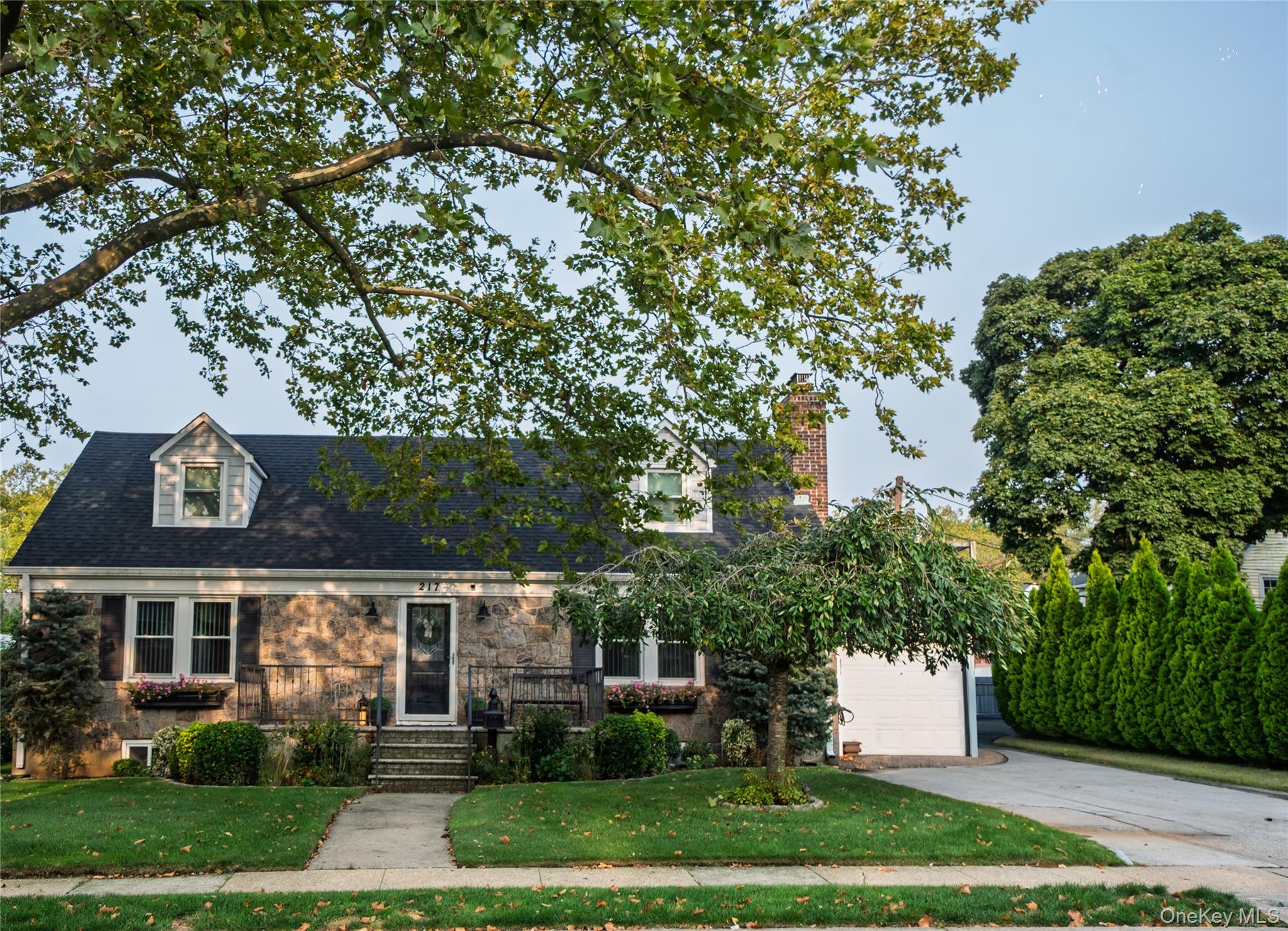 Welcome to this stunning 4-bedroom, 2-bathroom home featuring a finished basement and an inviting open floor plan. The gourmet kitchen boasts a granite island, granite countertops, and state-of-the-art stainless steel appliances, perfect for both everyday living and entertaining. Gleaming hardwood floors flow seamlessly throughout the home, adding warmth and elegance. Enjoy outdoor living with a charming front porch and a spacious back patio, ideal for relaxing or hosting gatherings. This home beautifully combines comfort, style, and functionality-truly a must-see! This home is located in Elmont School District with Sewanhaka High School