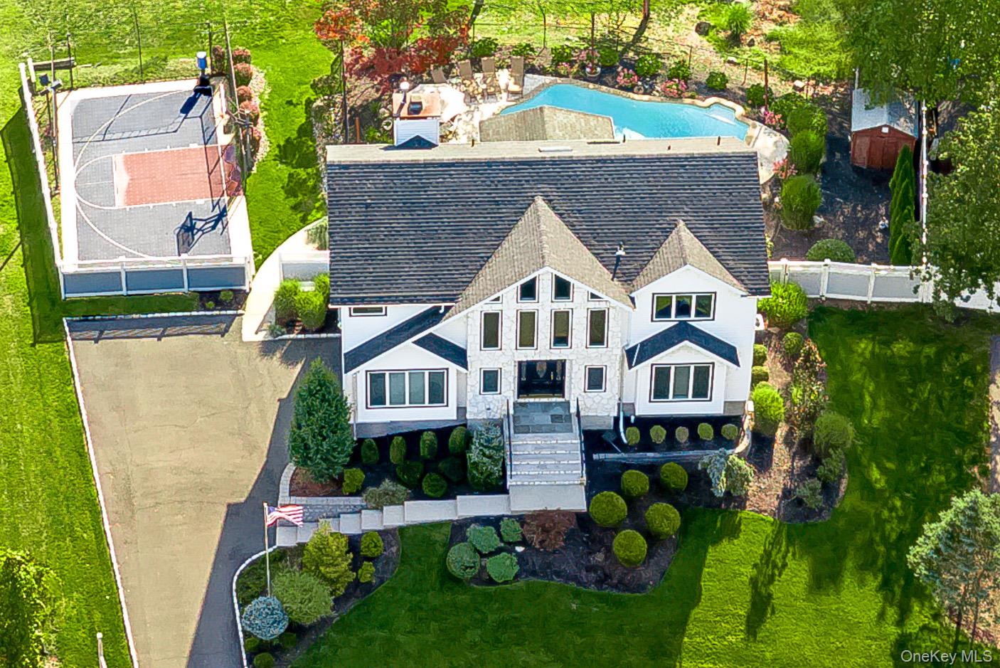 MUST-SEE GRAND COLONIAL! Perfectly situated on a stunning property, this exceptional residence showcases a sparkling gunite pool and a private sports courtâ€”your own resort at home. WOW, welcome to perfection! The main floor is designed for both comfort and entertaining, featuring a state-of-the-art eat-in kitchen with rich cherry wood cabinetry, granite countertops, and high-end stainless steel appliances. The inviting family room with fireplace, elegant formal living room, and gracious dining room provide seamless spaces for gatherings. Just off the kitchen, a spectacular three-seasons room offers panoramic views of the breathtaking grounds. Upstairs, four spacious bedrooms await, including a primary suite with a full bathroom and walk-in closet. Updates include: roof (2019), windows (2019), pool heater and filter (2019â€“2020), boiler (2020), new carpet upstairs (2020), primary bathroom (2020), and AC (2025). All of this rests on a magnificent property that truly has no duplicateâ€”a one-in-a-million opportunity. Come, fall in love, and youâ€™ll never want to leave.