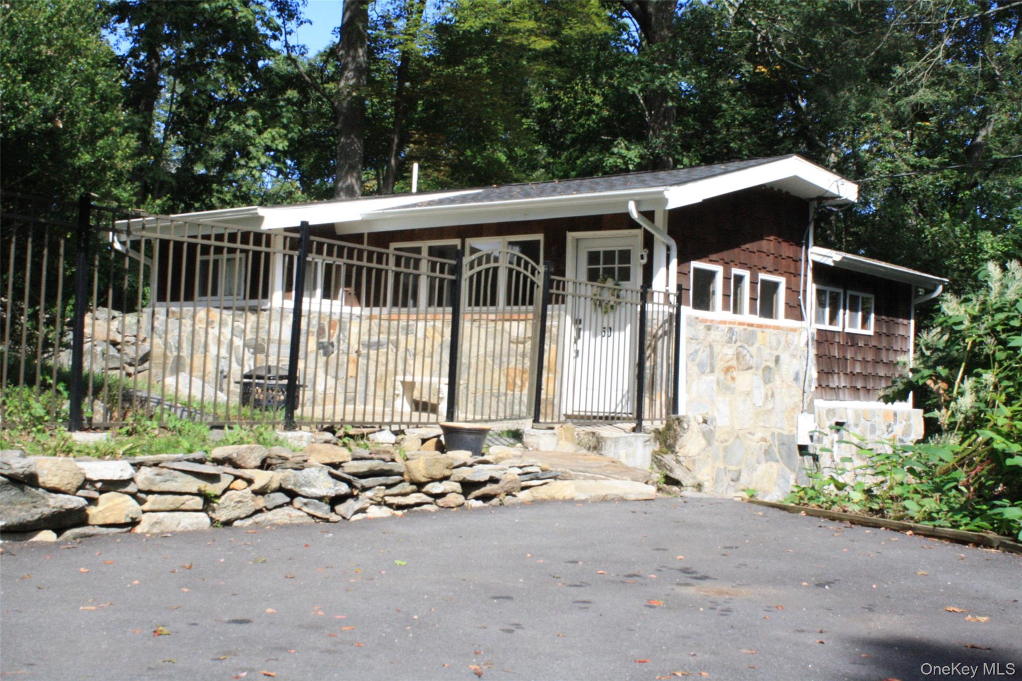Charming Private Cottage. On top of the hill, New Driveway, New Roof,  new Washer/Dryer, new refrigerator, Bathroom has been renovated, New Water heater,  , 2 bedrooms-Main bedroom has its own deck with private wooded view, Open the 2 large glass doors off the eat in Kitchen to a private deck perfect for morning coffee or those outside summer meals. Living room has a high cathedral ceiling- shining wood floors, and an area for a possible office space, The outside private fenced and gated yard includes a shed for storage, You will be surprised by the amount of living space in this small will maintained cottage. Park on the new driveway, open the gate and enjoy this gem of a home. Owner will consider financing ask listing Broker for details.