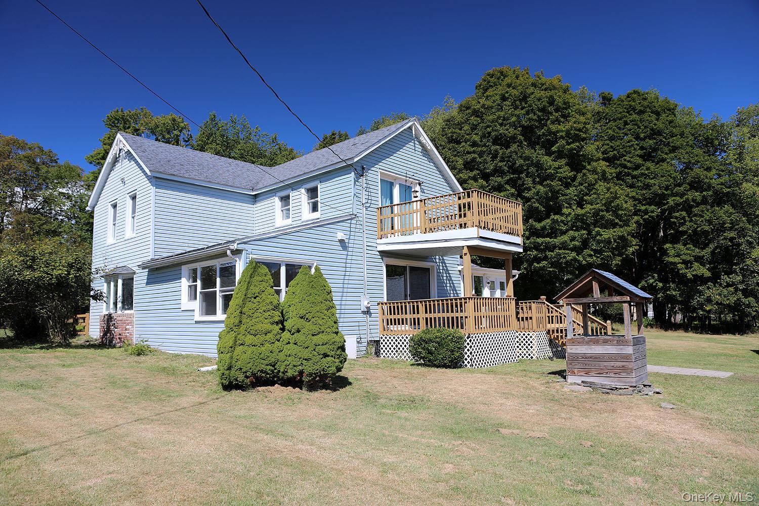 Check out this stylish Catskills retreat featuring 3 bedrooms and 2 full baths! This chic two-level home has been completely remodeled and sits on about 3.5 level acres with a 2-car garage. You&rsquo;ll love its gleaming wood floors and massive brick fireplace in the LR. The main living area has a bright, sunny entry, updated spacious kitchen with granite counters and SS appliances, with a convenient laundry area just off it. A wrap-around deck makes outdoor entertaining a breeze; just step through the sliding doors from kitchen or dining room. The dining room has sliders which open to the covered deck for al fresco meals. You&rsquo;ll continue into the family room (or use this as a main bedroom on the first floor!) with plenty of light and terrific views. Then as you step into the living room, you&rsquo;ll see the focal point is the gorgeous brick fireplace! Don&rsquo;t forget the full bath on this level: the soaking tub will make you want to immerse yourself in bubbles and forget the world! Moving upstairs, there are three bedrooms and another full bath-- one of which opens to its own private balcony. Don&rsquo;t forget the basement: has its own entrance and has been fully moisture-proofed; great for storage. Outside, find a nice level lawn for gardening, evening firepits, or even add a pool! The 2-car garage is a nice bonus. This nearly 2000-square foot residence offers the Catskills weekend lifestyle you&rsquo;ve been searching for! You&rsquo;ll love its central location-- just 10 minutes to Callicoon and the Delaware River with the popular Sunday Farmers Market, eateries, theater, and pickleball. And only 15 minutes to Narrowsburg with its brewery, art scene and terrific restaurants! Bethel Woods Center for the Arts is just a short drive for concerts and Harvest Markets. Less than 2 hours from the GWB, it&rsquo;s a totally manageable day trip for a visit, and once you get here you may not want to leave!