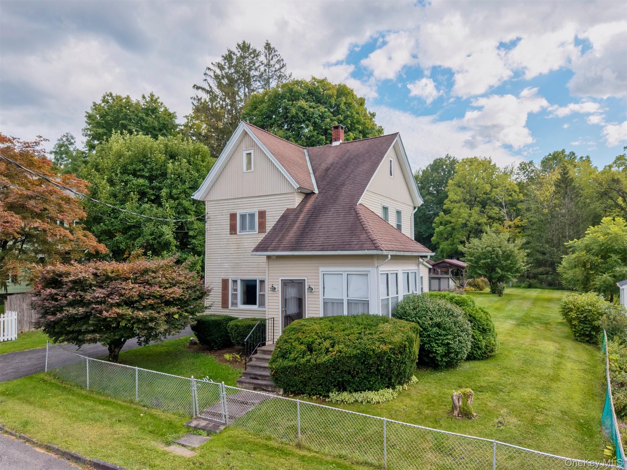 Welcome to 23 Maple Street in Rifton, where character and charm meet a serene streamside setting. This 2-bedroom, 1-bath home offers 1, 238 square feet of living space on a picturesque half-acre. The inviting floor plan features a spacious eat-in kitchen, a bright living room with hardwood floors, and a versatile room ideal for a home office, nursery, or creative studio. An enclosed back porch/three-season room provides the perfect spot to relax and enjoy the peaceful surroundings year-round. Outdoors, the property is just as special, with a level yard for gardening or recreation, multiple sheds for storage, and even a private sauna for at-home relaxation. Low-maintenance features such as vinyl siding and asphalt shingle roofing add convenience. Nestled in the quiet hamlet of Rifton, this property offers both privacy and easy access to New Paltz, Kingston, and all the Hudson Valley has to offer. A truly unique opportunity to enjoy a blend of comfort, charm, and natural beauty.