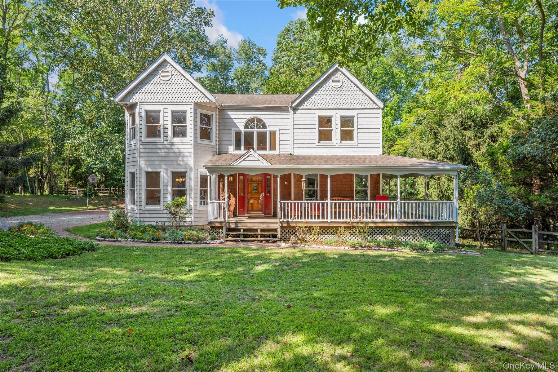 Welcome to this timeless Victorian-style residence, perfectly situated on 1.3 acres of tranquil, wooded grounds. Offering four spacious bedrooms and three-and-a-half bathrooms, this home blends classic architectural charm with modern comfort.A welcoming covered front porch sets the stage for relaxed mornings and evenings. Inside, hardwood floors and ornamental moldings and french doors add character throughout. The formal living and dining rooms are ideal for entertaining, while the cozy den with fireplace invites you to unwind. The kitchen features wood cabinetry and thoughtful updates, complementing the homeâ€™s historic style. The primary suite has been tastefully updated with a modern en suite bath, creating a private retreat. A full walkout basement and a three-car garage provide exceptional storage and functionality. Perfectly located on a private road, close to beaches, shopping, restaurants and award-winning wineries, this home offers both peaceful privacy and convenient access to the best of the North Shore lifestyle.