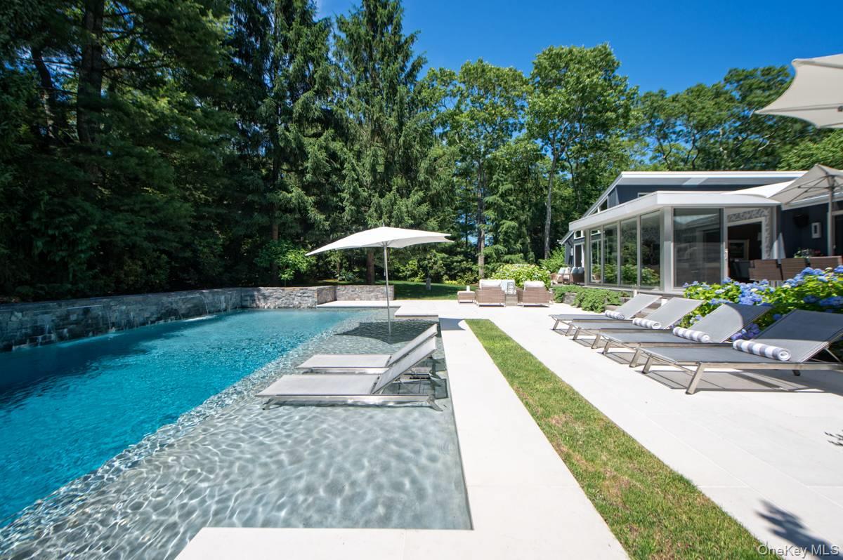 Hands Creek Harbor StunnerThoughtfully renovated from top to bottom, this pristine 3 bedroom/ 2.5 bath contemporary has been meticulously updated. Soaring, bright living room has 15&rsquo; vaulted ceilings, shiplap paneling, quartz clad fireplace and sliders to the front and back decks. A separate elegant dining room adjacent to a floor to ceiling glass sunroom offers true indoor/ outdoor living. Newly renovated kitchen has marble countertops, SubZero, Miele and Wolff stainless appliances. The primary en suite occupies the rear of the home with floor to ceiling windows and sliders to a private deck overlooking the pool and professionally landscaped grounds. Two additional bedrooms with skylights and another full bath complete the first level. The lower level is comfortably finished with a large media room, marble clad bar with SubZero wine fridge, beverage center and ice maker, generously sized home office with custom built-ins, fully equipped gym, powder room, laundry, huge custom walk in closet and large finished storage area. Outside, the beautifully landscaped and illuminated grounds abound with mature plantings, masses of hydrangeas, azaleas and multiple specimen trees allowing for year round greenery and maximum privacy. The oversized spa like pool is gunite, heated, saltwater and has a large sun shelf that can accommodate 6 loungers. Two waterfalls spill from a custom cut stone wall that wraps around the pool and ends with a fire feature. The home is in the coveted Hands Creek Harbor association with a private 2 acre water front parcel with access for kayaks and paddle boards into Three Mile Harbor. Minutes to Sammy&rsquo;s Beach and Northwest Harbor. A true gem.