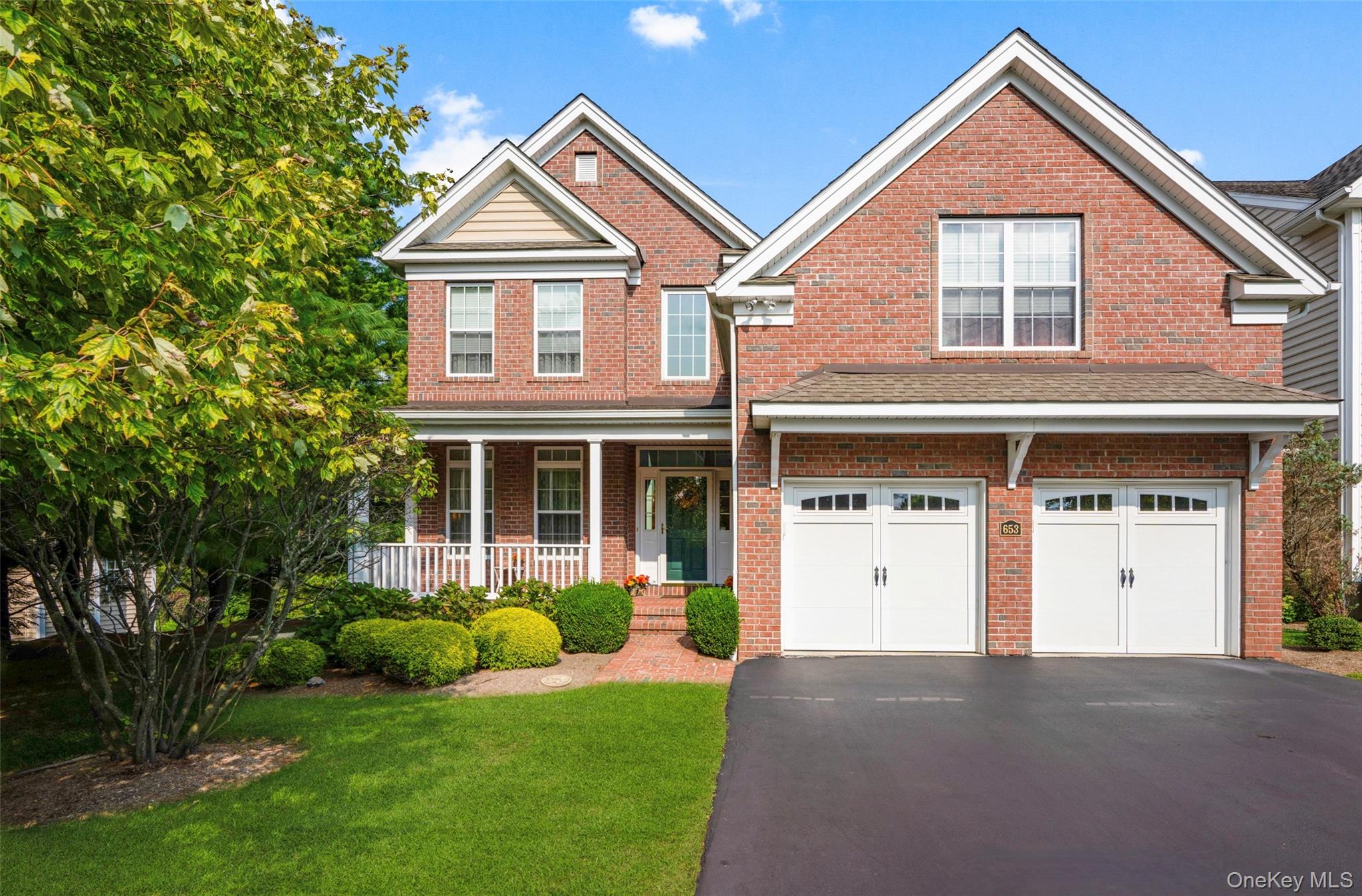Stately brick colonial set on a premium homesite in the desirable Van Wyck Glen community in Fishkill, this home showcases custom construction with extensive upgrades and elegant finishes throughout. Step into the dramatic two-story entry foyer, where hardwood floors lead to a formal living room with tray ceiling and an elegant dining room, ideal for entertaining. The heart of the home is a gourmet kitchen, complete with designer cabinetry, granite counters, a large center island, and a GE Profile appliance package including, double ovens, convection oven, a professional range, and hood with exterior venting. A spacious breakfast bar with granite countertop, tons of storage, and seating connects the kitchen to the inviting family room, which features a cozy gas fireplace, bay window, and Bose surround sound. French doors extend the living space to a sun-drenched solarium with vaulted ceiling and walls of windows overlooking the tree-lined backyard and stunning mountain views. From here, step out onto the deck, where you can continue to enjoy the same sweeping views. A private study with custom built-ins completes the main level, offering the perfect home office, play room, or quiet retreat. Upstairs, the primary suite impresses with double doors, a tray ceiling, sitting room, custom walk-in closet plus two additional closets, and a spa-like bath with dual vanities, makeup station, soaking tub, separate shower, and water closet. Two spacious secondary bedrooms with hardwood floors and fourth bedroom with double closets and vaulted ceilings. The finished lower level offers exceptional versatility with a full bath , laundry room, exercise room, recreation room, storage room, and a sliding glass door leading to a private hardscapped patio overlooking the backyard. This layout is perfect for an in-law suite, extended family, or private guest retreat. Set on a premium homesite that backs to protected forever green space, providing year-round privacy and scenic views. Additional highlights include three zones of heating and air conditioning, a new hot water heater, A/C condenser and handler (2023), municipal water and sewer, security system, upgraded interior and exterior lighting, underground electrical services, custom closet systems, water softener system, Hunter Douglas Silhouette blinds, and upgraded Kohler fixtures. This community offers excellent amenities, including a pool, clubhouse, exercise room, playground and tennis courts. Ideal location, just minutes from shopping, schools, restaurants, the Village of Fishkill Main Street, I-84, Taconic State Pkwy, and I-87. Only 55 miles to Manhattan and 8 miles to the Metro North Train Station which goes directly into Grand Central Station. See floor plan.