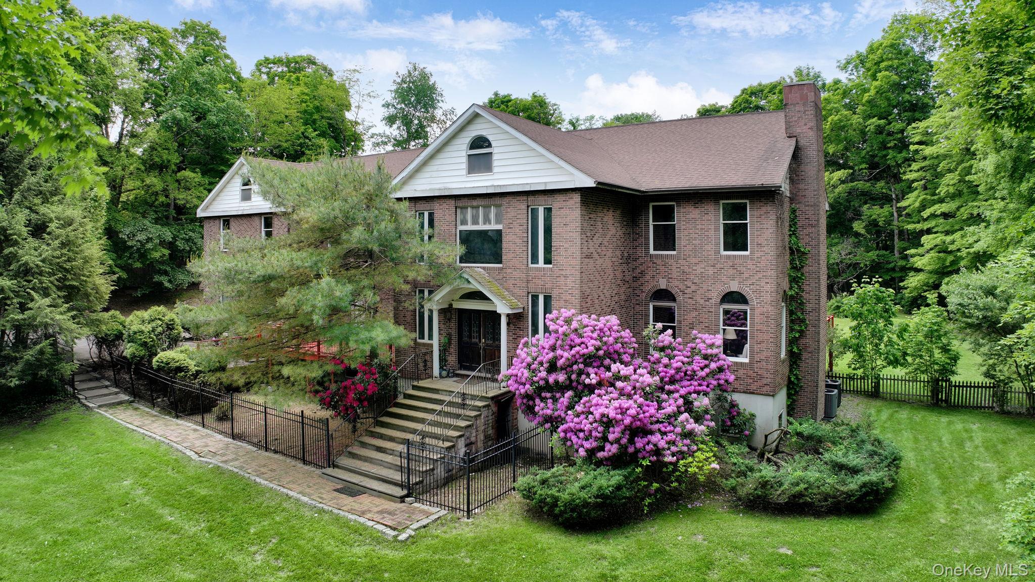 Set on 11.1 private acres in the heart of Millbrook, this stately brick Colonial estate offers over 11, 222 square feet of refined living space, combining timeless elegance with exceptional versatility. A true legacy property, it delivers the scale, design, and amenities expected by the most discerning buyers.A dramatic two-story granite foyer welcomes you with a sweeping double staircase and a dazzling chandelier. The main level features a formal living room with fireplace and wet bar, a richly appointed library, and a spacious family room with its own fireplace. The chef&rsquo;s kitchen is finished in Chinese marble and granite, centered around a large island, and opens into a soaring two-story solarium with fireplaceâ€”perfect for year-round entertaining. A formal dining room with teak floors completes the main living spaces.Upstairs, the luxurious primary suite includes a spa-style bath, while additional bedrooms, a nursery, and a private in-law apartment offer flexible accommodations. The lower level is fully finished with a media room, workshop, utility room, and a dedicated office suite featuring two exam rooms and a waiting areaâ€”ideal for a private practice or creative studio.Additional features include a 4-car attached garage, a separate guest bungalow, and a beautifully landscaped in-ground pool. The expansive grounds offer privacy and serenity, just minutes from Millbrook Village and under two hours from New York City.