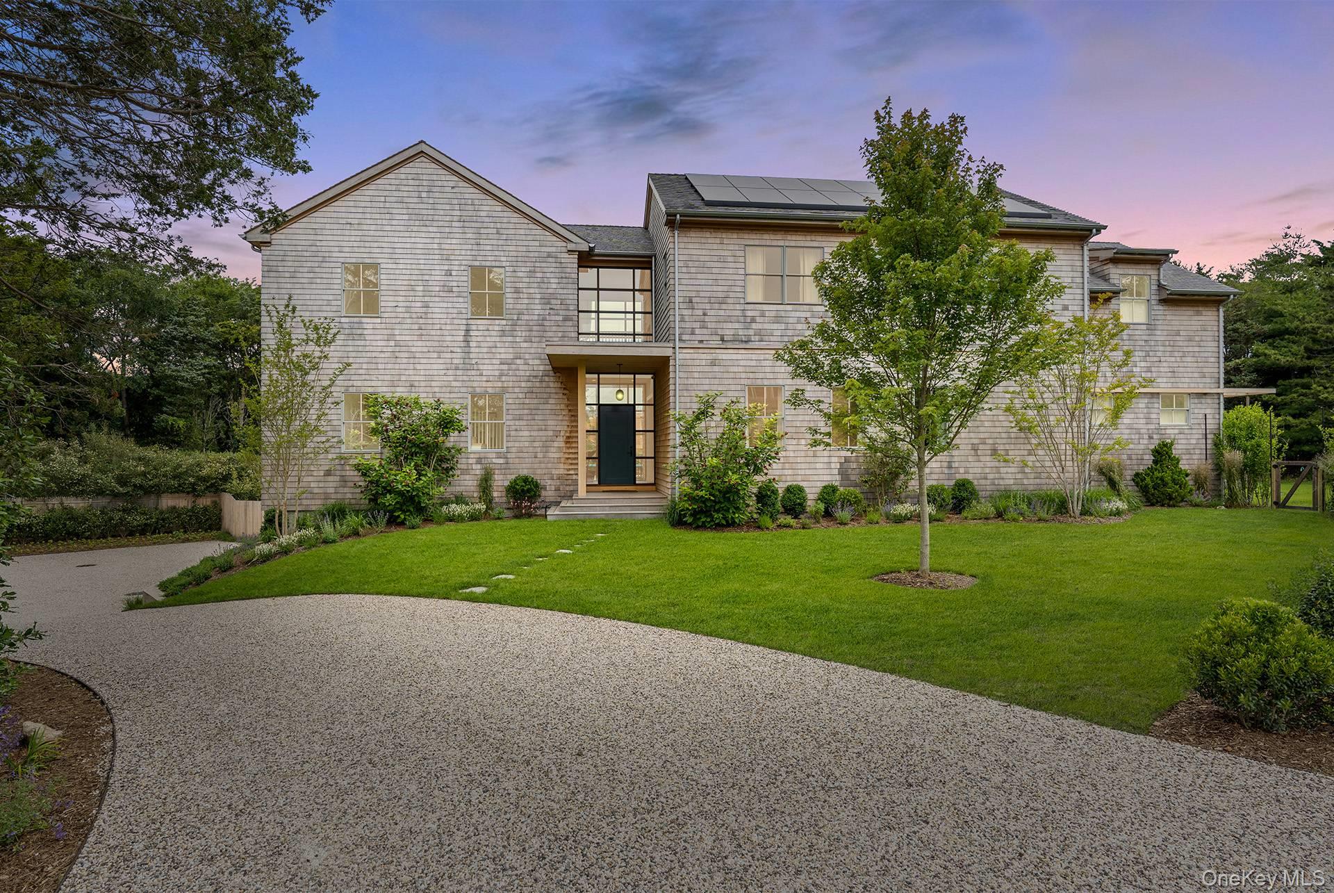Located in Water Mill, South of the Highway, with access to Mecox Bay, on a coveted, private lane, this luminous, new shingle-style construction features 6 bedrooms, 6.5 baths and 2 fireplaces across 5, 400+ sf of living space. A light-filled entry leads to an open, spacious living room in a home featuring modern Asian decor. Five ample sliding glass doors open directly to the bluestone back patio, a heated gunite 20x40 pool, and a beautifully-landscaped backyard. The home also offers 2 primary suites with separate showers and soaking tubs, 4 ensuite bedrooms, including one with its own private entrance and patio. On the second floor, there are a library/meditation room and a private office space. The ground floor includes a recreation room with a ping-pong table and one bay within the 2-car attached garage. Additional amenities include multiple outdoor areas for dining and entertaining, a gas-fired grill, a covered loggia, outdoor shower, and solar panels with backup electric storage. Just a few hundred feet down the road is water access to Hayground Cove and Mecox Bay beyond, perfect for kayaking, canoeing, or paddle boarding.The pristine Flying Point Beach is just a short distance away on the quiet back roads of quaint Water Mill.