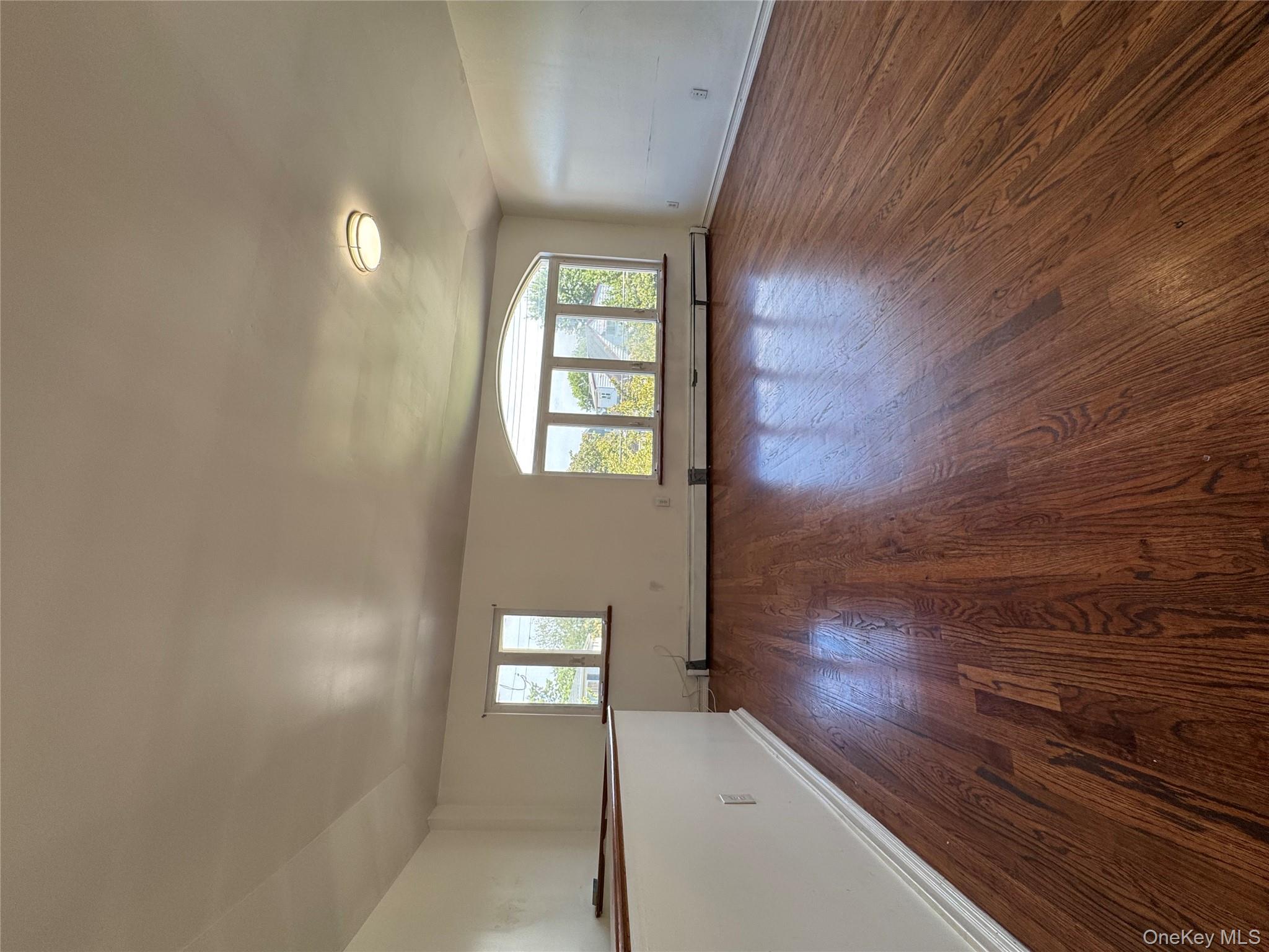 Spacious 3-bedroom 2-bathroom unit for rent on the 2nd floor, approx. 1, 100 sq. ft. Features a large living room with high ceilings, hardwood floor throughout, a primary suite, and access to a shared backyard. Easy street parking. Conveniently located near JFK, Q40 bus, park, and supermarket. Water included in rent. No pets, no smoking.