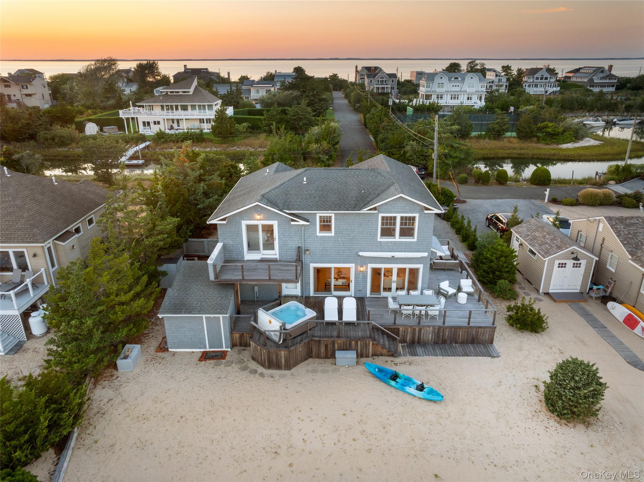 Set along the shoreline of the coveted Cold Spring Point Beach Community, this newly reimagined beach house with a private dock offers the perfect balance of Hamptons sophistication and laid-back coastal living. From sunrise to sunset, enjoy sweeping water views and tranquil surroundings that define the essence of waterfront life.Curated by renowned interior designer Purvi Padia, with exquisite lighting by Lindsey Adelman, the home radiates refined elegance while embracing an airy, beachside charm.The sunlit open-concept living space features vaulted ceilings and expansive sliding glass doors framing panoramic vistas of Cold Spring Pond and the sandy beach. A chefâ€™s kitchen with premium stainless-steel appliances and sleek Carrera marble countertops flows seamlessly into a spacious great room, designed for both relaxed gatherings and elegant entertaining.The first floor offers a full bathroom with laundry and a versatile bonus room with wall-to-wall closetsâ€”ideal as a home office, den, or guest suite.Upstairs, the private primary suite boasts an upper deck overlooking the water, a beautifully renovated en-suite bath, and a generous custom walk-in closetâ€”crafted for comfort whether for weekend escapes or year-round living. Two additional oversized bedrooms, each with water views, share a tastefully updated bathroom, providing ample space for family and guests.Outdoor living is elevated by a newly built IPE wraparound deck with an expandable awning, dining and lounge areas, and a soothing hot tubâ€”perfect for unwinding after a day on the water.Launch your boat from the rebuilt deeded dock with new pilings, enjoy a leisurely kayak along the pond, or take advantage of the community tennis courts just steps away. A short stroll in your flip-flops brings you to the Great Peconic Bay beach for a refreshing swim.This exceptional property presents a rare opportunity to experience waterfront living in one of the Hamptonsâ€™ most sought-after private beach enclaves.