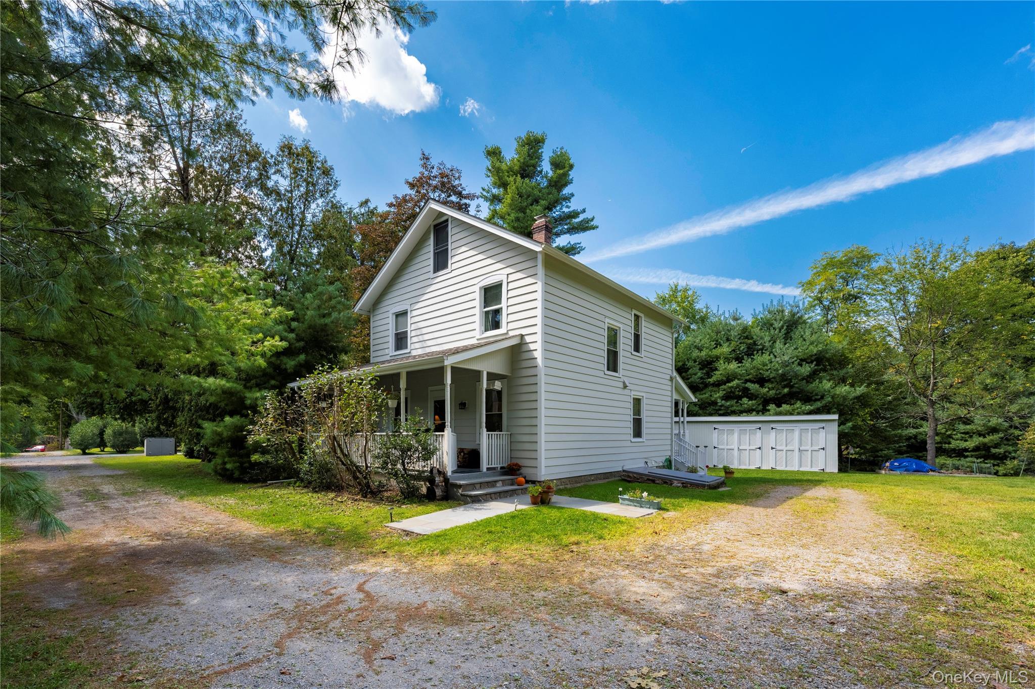 In the heart of Garrison, this three-bedroom home is on nearly 1.5 level acres along a quiet road. A welcoming front porch leads into the living room with a wood-burning stove, high ceilings, and hardwood floors, connecting easily to the dining room. The kitchen, large enough for a breakfast table, opens to a second porch at the back of the house, an ideal spot for morning coffee or evening unwinding.Upstairs are three bedrooms and a full bath, with a landing spacious enough to serve as a home office. The level property offers room for gardens, play, or gatherings, and has space for a pool if desired. A detached garage fits two cars, with a third bay for storage, a workshop, or small projects. The exterior of the house and garage have recently been painted.From here, itâ€™s a short walk to the train, local schools, and the shops of Cold Springâ€™s historic village. Quiet and private, the home balances convenience with the beauty and ease of Hudson Valley living.
