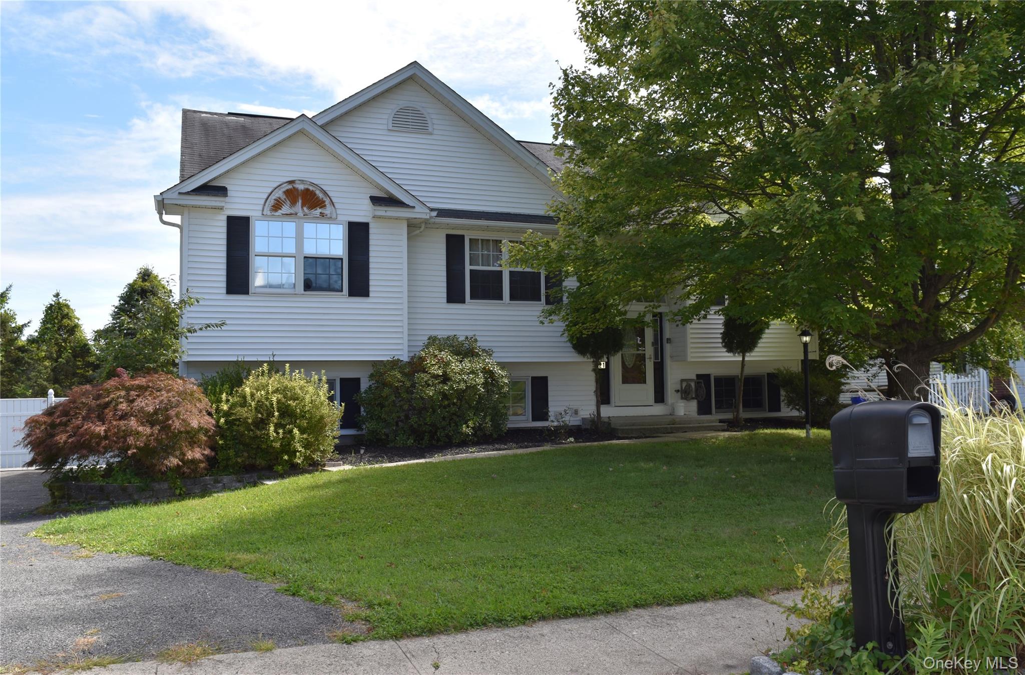 Spacious 5-Bedroom Raised Ranch on a Quiet Cul-de-Sac in the Village of Walden! Welcome to this beautifully maintained 2, 400 sq ft home, perfectly situated at the end of a peaceful cul-de-sac. This spacious home offers 5 bedrooms and 2.5 bathrooms, providing plenty of room for family, guests, or a home office setup. The upper level features a bright, open-concept layout with a large kitchen, breakfast bar, pantry, and stainless steel appliances. The living room boasts cathedral ceilings, creating an airy and inviting atmosphere, and flows seamlessly into the dining room with sliders leading to an expansive deckâ€”ideal for outdoor entertaining. Three bedrooms and two full bathrooms complete this level, including a primary suite with its own private bath. The lower level offers incredible versatility with two additional bedrooms, a generous open living area, and a half bathâ€”perfect for a family room, guest quarters, or even a home gym. Additional highlights include natural gas heat, central air, municipal services, and a private backyard thatâ€™s perfect for relaxation. Located just minutes from shops, restaurants, and parks, this home combines privacy with convenience.
