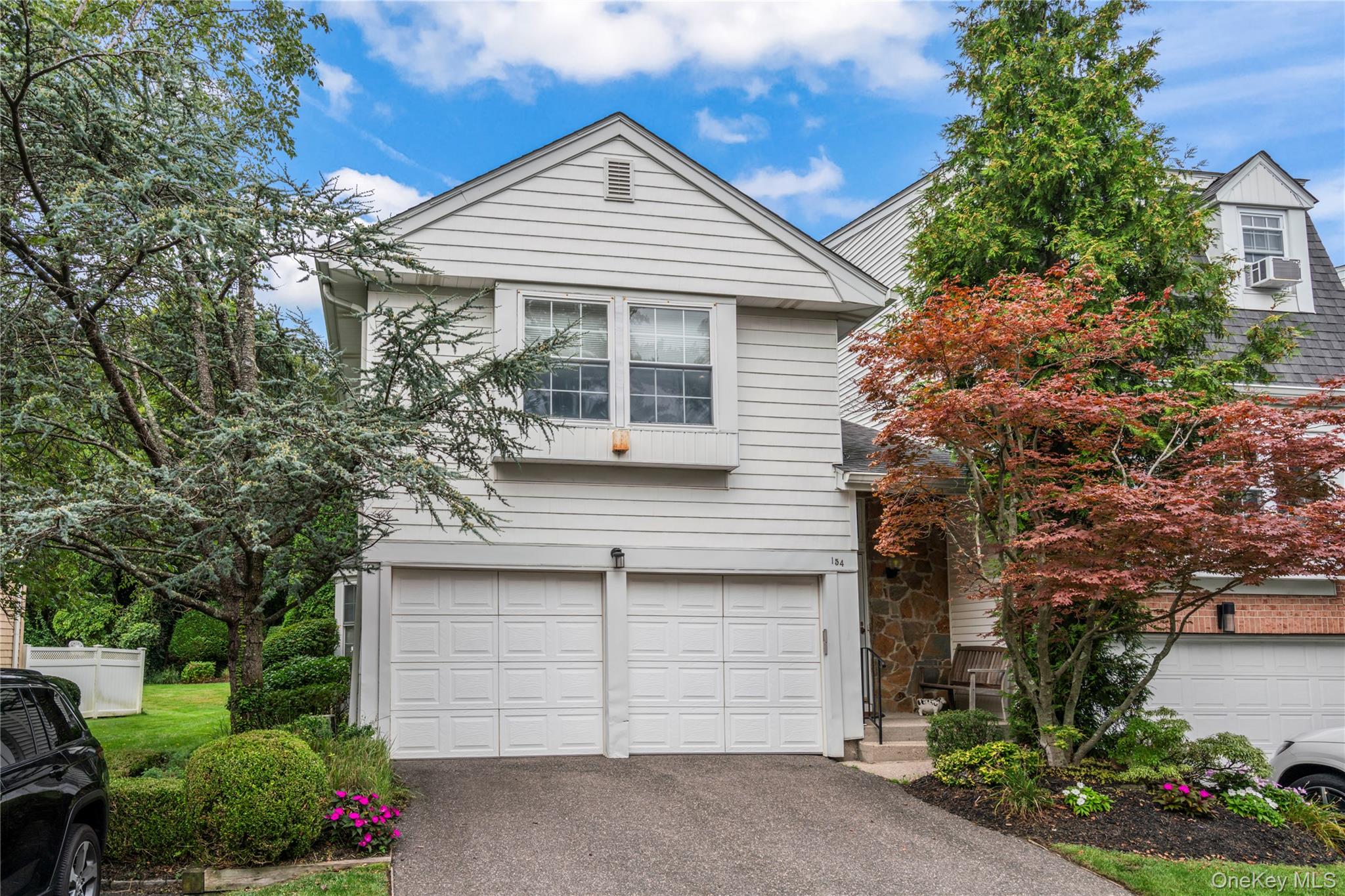 Welcome to this Exquisite End-Unit Vale Model in the Prestigious Guard-Gated Community of Hidden Ridge! This beautifully renovated residence offers 3 spacious bedrooms, 2.5 updated baths, a finished basement, and a 2-car garage with a private driveway. The updated kitchen features quartz countertops and stainless-steel appliancesâ€”designed with quality and attention to detail. The expansive primary suite includes a large walk-in closet and a renovated spa-like bath with a double vanity, soaking tub, and walk-in shower. The finished basement provides exceptional additional living space, complete with an air ventilation system and a custom wine cellarâ€”ideal for both entertaining and everyday comfort. Additional highlights include gleaming hardwood floors, surround sound in the living room and a cozy fireplace. Step outside to your gated deck overlooking a lush greenbelt oasisâ€”perfect for entertaining or simply relaxing in total privacy. Hidden Ridge offers resort-style amenities including a pool, tennis courts, clubhouse, and playgroundâ€”delivering the ultimate country club lifestyle. Conveniently located near major highways, shopping, dining, parks, schools, and the LIRR. Prestigious Syosset School District (AP Willits Elementary, HB Thompson Middle, Syosset High School). Move right in and enjoy your own private oasis with luxury living at its finest!