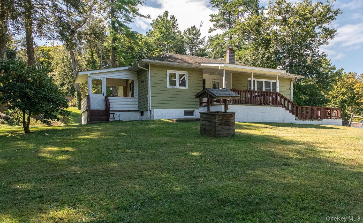 What a fantastic value! This home, offering three bedroom options, has always lived as a three bedroom. You will be inpressed with the size of the kitchen, its generous dine-in area, built-in pantry, solid wood cabinetry, ceramic tile flooring and a door to a cute side porch; a perfect place to enjoy a meal outdoors. The living room is cozy and bright, bathed in natural light streaming in through the wall of windows. Enjoy hardwood floors throughout the main level. As you head down to the lower level, discover loads of storage space as well as a finished recreation room with a door out to the driveway. The property is lovely. The house is set back from the road atop a gentle knoll, surrounded by a backdrop of mature trees. Enjoy tree-line views from the front porch or partake in a host of outdoor activities in the expansive, level backyard. Located in historic Hyde Park, close to shopping, eateries, the Poughkeepsie train station, major highways, hospitals, the Culinary Institute of America, Marist College, Vassar College and all that the fabulous Hudson Valley has to offer.