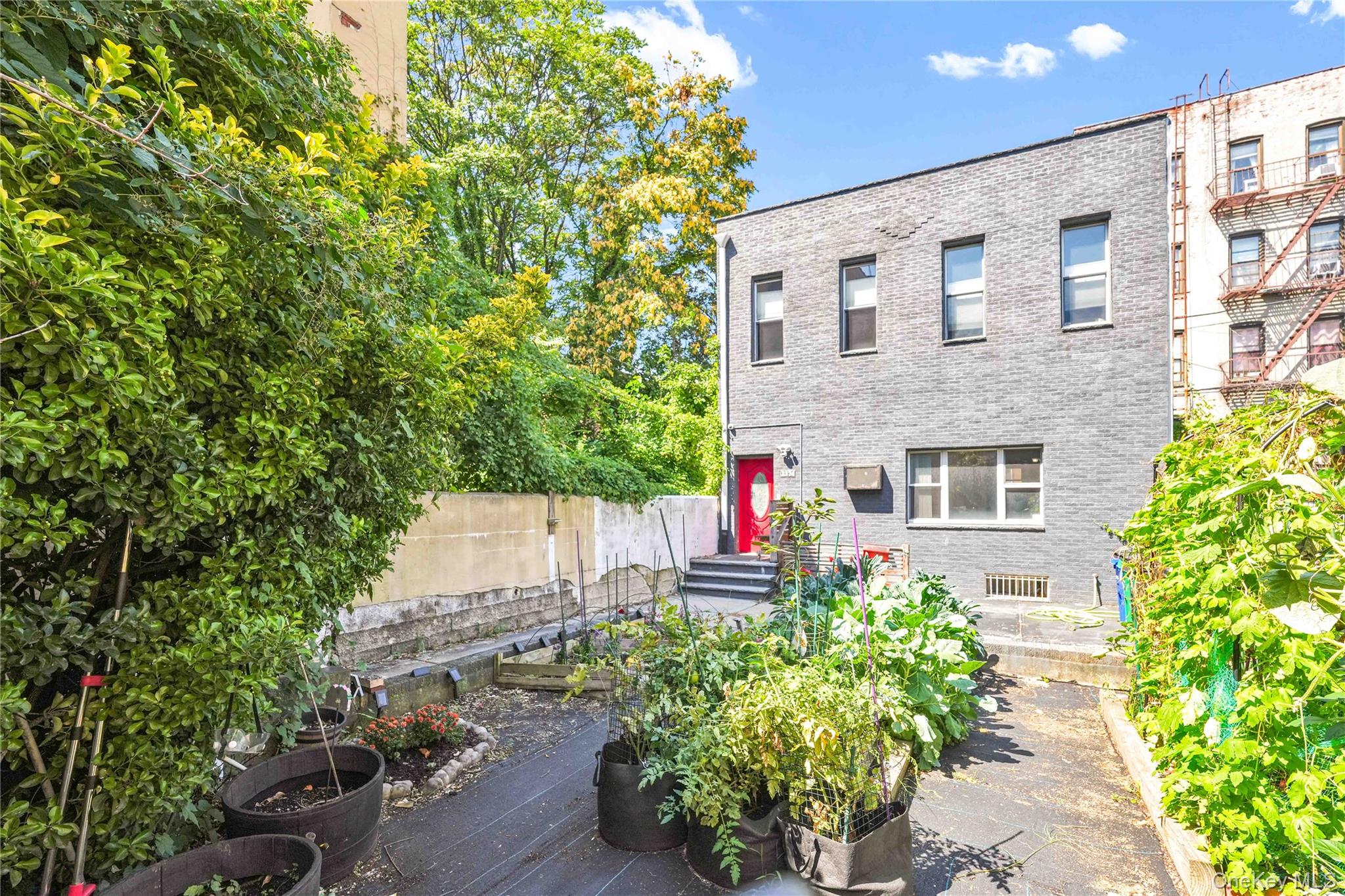 Welcome to this rarely available, completely detached single-family home in the heart of Astoria. Uniquely set back from the street, the property offers exceptional privacy and tranquility, creating a hidden oasis right in the neighborhood.The entryway welcomes you with a lush front garden, where raised beds and greenery create a private retreat perfect for the buyer with a green thumb. The property also features a fully detached, newly built brick-garage (2024) with wall-to-wall construction, a brand-new roof, and top-tier insulation for year-round comfort. It provides an ideal blend of functionality and convenience, with one-push remote access from the street on one side, and a throughway complete with full glass storm door and metal safety door, a walk to the garden and home. A private driveway adds even more parking and storage convenience.Upon entering, youâ€™re greeted by a bright foyer and wood staircase leading up to the living quarters. The spacious living room is wider than the average Astoria home, thanks to the homeâ€™s extra-wide 25-foot footprint (compared to the typical 18â€“20 feet). Natural light fills the interiors through four impressive 68-inch front-facing windows, which are beautifully set against the homeâ€™s dark grey brick fa&#231;ade, lending it both the distinguished presence of a mansion from a bygone era and the elegance of modern design. Inside, soaring 10-foot ceilings on the first floor and 9-foot ceilings on the second floor provide an airy sense of space rarely found in Astoria single-family homes.The first floor flows seamlessly from living room to dining room and into the windowed kitchen, outfitted with granite counters, a gas range, and a dishwasher, perfect for both everyday living and entertaining.One of this homeâ€™s most unique and rare features is a full bathroom on the first floor, something seldom found in Astoria single-family homes. It features a tub, vessel sink, and wood finishes that blend practicality with charm. The second floor includes another full bathroom with a glass-enclosed shower, copper sink, and antique-style fixtures, adding elegance and character.On the top floor, youâ€™ll find a true three-bedroom layout, an uncommon find in the area where third bedrooms are often small and narrow. Here, generously sized rooms, hardwood floors, and a skylight fill the home with abundant natural light.The basement provides additional living and storage space with the benefit of a separate entrance from the front of the home. With washer and dryer hookups, it is ready for your laundry needs, while the flexibility of the space makes it ideal for a home office, gym, recreation room, or guest suite.Another key advantage of this property is the lower property taxes. At approximately $5, 400 per year, they are significantly less than the Astoria single-family average of around $8, 000, making ownership more affordable and appealing.The property also offers valuable long-term potential, being zoned R5, permitting the addition of a two-family home, an extension, or space for a swimming pool in the front yard.Just a short walk to the N/W subway to NYC (only three stops from Astoria Blvd to 59th Street in about 10 minutes), and with additional access to the M60 bus to LaGuardia Airport and the Q19 to Northern Blvd/Flushing, transportation is a breeze. Close to all major highways, Grand Central Parkway, Ed Koch Queensboro Bridge, RFK Bridge, and the BQE. Youâ€™re just a few miles from LaGuardia Airport & JFK Airport.For recreation, Astoria Park is less than ten minutes away, offering a swimming pool, tennis courts, basketball courts, picnic areas, a running track, and a dog-friendly area, perfect for outdoor activities and family enjoyment.With its unmatched blend of privacy, space, and value, 38th Street stands out as one of the most exceptional single-family opportunities in Astoria.