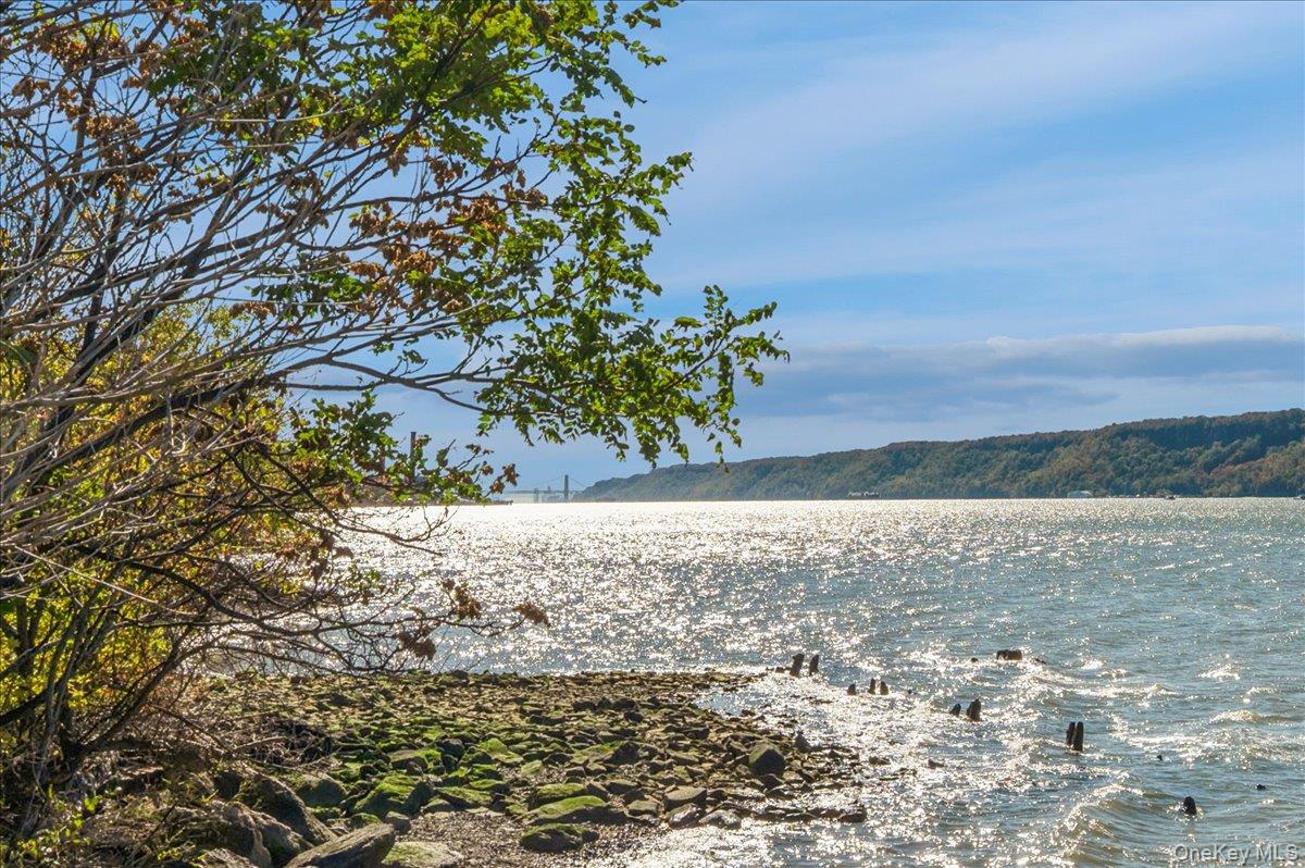 Imagine waking up to incredible views of the Hudson River and the Palisades every day from this bright and sunny 2-bedroom, 2-bath apartment at the Riverwatch Condominium. This home has it all: 2 very large bedrooms with generous closet space, 2 full bathrooms, and an updated kitchen featuring wood cabinets, granite countertops, and stainless steel appliances. Both the living room and bedroom have access to a large terrace which spans the length of the apartment. The primary bedroom has an en suite bathroom and its own private terrace. There are engineered wood floors throughout. The building is pet-friendly, has a laundry on every floor, and a 24-hour doorman. The Fitness Center and Seasonal pool are included. A deeded, assigned parking spot and storage unit.are also included. Metro North is across the street with an under-30-minute commute to Grand Central. Enjoy the nearby Croton Aqueduct Trail for a leisurely walk or bike ride. The village of Hastings is 5 minutes away with multiple dining choices. Come see this home today