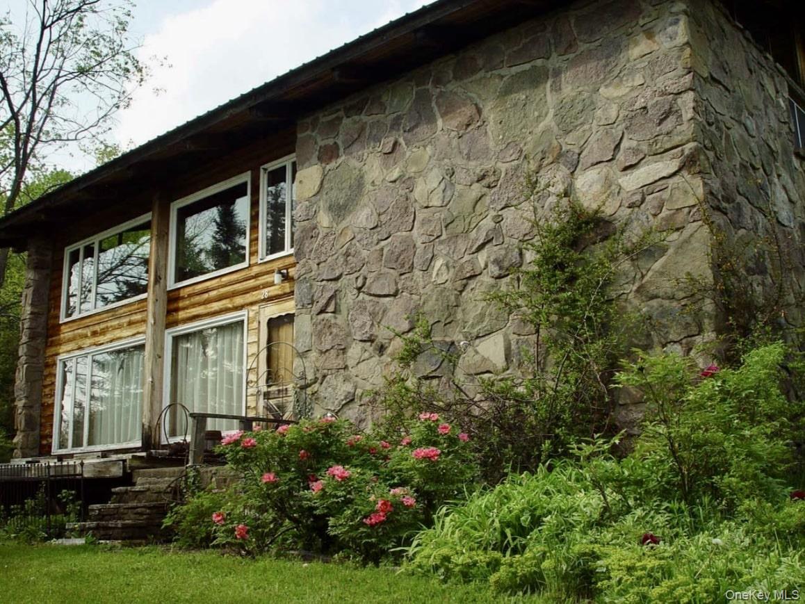 Welcome to a truly special property - designed as a replica of a classic chalet in the ski region of St. Martino, Italy, and brought to life by the original owners after discovering the design in a 1960s architectural magazine. This home is more than a place to live; itâ€™s a work of art steeped in story and style inspired by the Italian Alps.Set on 15 acres, the home is surrounded by mature landscaping, including perennial shrubs, flowering gardens, a small pond, and a 30-year-old climbing hydrangea that drapes gracefully along the stone corner of the house. An apple orchard provides bushels of red and green apples every fall with the adjacent field providing breathtaking mountain views. Inside, cathedral ceilings with exposed beams create an airy and expansive feel in the living room, which is filled with natural light from oversized windows and features an open-concept balcony above. The warm cedar siding throughout the interior pairs beautifully with the fieldstone wallsâ€”crafted from stone harvested directly from the property itself. A custom-built coffee table, made from a tree felled onsite, and other handcrafted furnishings built specifically for this home (many of which are included in the sale) add to the authenticity and charm. The property also includes a barn perfect for storage or hobby use. The house has a durable metal roof for long-term peace of mind. This is more than a homeâ€”itâ€™s a legacy property, a place where craftsmanship, history, and nature converge. You will not find this amount of character in a new construction. Homes with this level of architectural integrity and natural maturity rarely come to market. Donâ€™t miss the chance to own a piece of inspired living.