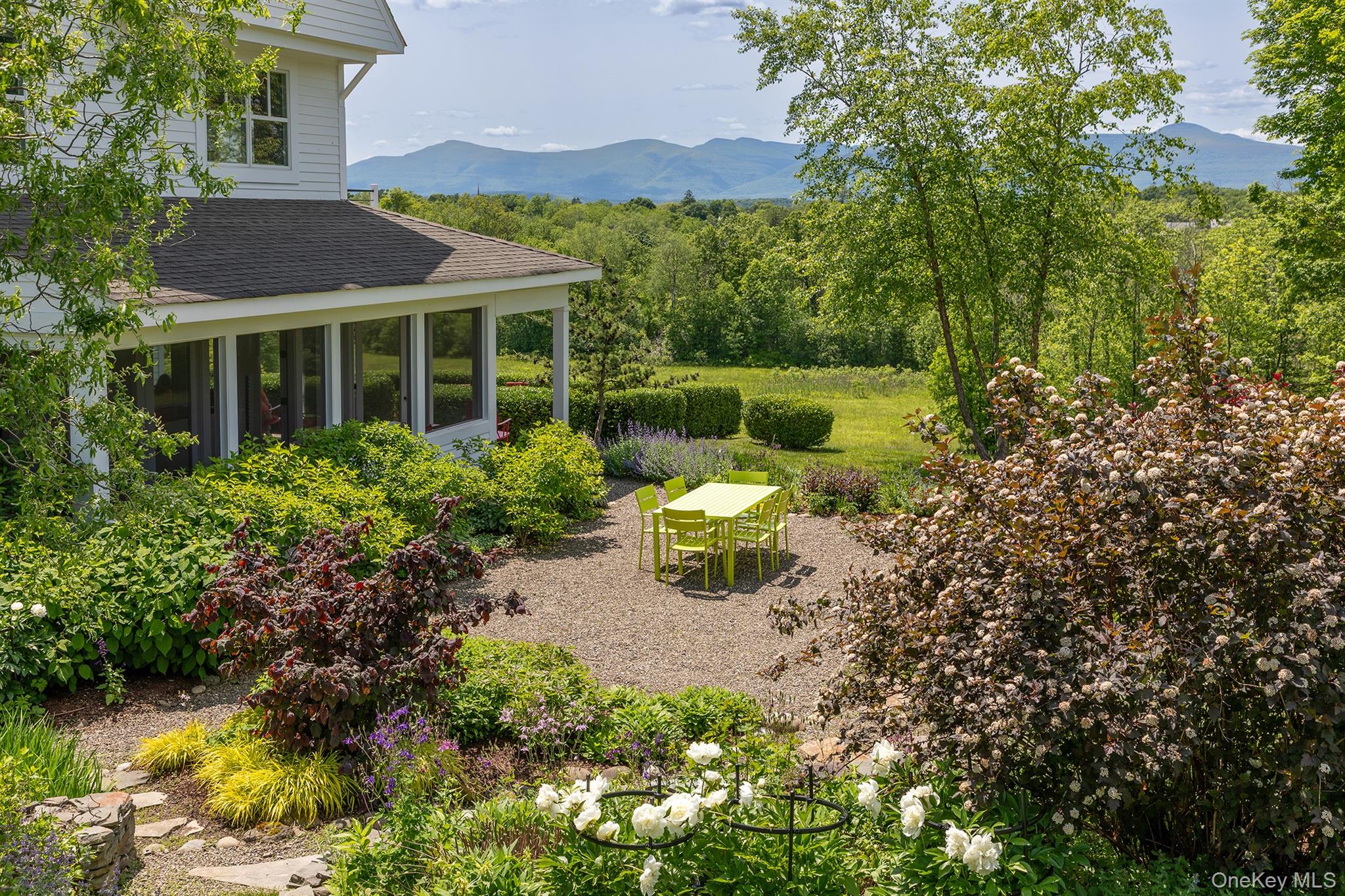 Location. Privacy. Views. Retreat to 336 Main Street, a hidden jewel in Germantown real estate. A mere half-mile from the center of Germantown&rsquo;s historic hamlet, a winding tree-lined driveway with park-like landscaping leads to this exceptional property. A transformed landscape of 8 acres includes rolling lawns, wooded acreage, and extensive and established perennial gardens, including significant massing of mature shrubs. Beyond the landscaped parking area is a dramatic reveal of one of Germantown&rsquo;s finest views of the Catskill Mountain range. From this vantage on a hill, the ever-changing sky hovers over layers of tree lines and open fields. The view is nothing short of spectacular, with sunrise turning the Catskills pink, and dramatic full-spectrum sunsets moving into starry nights throughout the year. The well-maintained house was entirely renovated by a multi-generational family of builders to exacting terms for the current owners. Stone walls and a bluestone path amongst flowering gardens leads to the house&rsquo;s front porch. Inside, the open-plan ground floor is filled with natural light through walls of windows and glass doors. A cooks kitchen is anchored by a massive Carrera marble island, with a 6-burner Viking Range, Subzero fridge, wall oven/microwave, twin sinks and dishwashers. Gatherings around the kitchen spill into the living/dining room, spaces leading to a large screened porch and an open porch overlooking the majestic mountain and garden views. 9- foot ceilings throughout enhance the rooms&rsquo; volume and space. Down a few stairs is a 3/4 bath next to the library and study, with views of the Catskills, meadows, and gardens. Pocket doors provide privacy for watching television or reading, and beyond, additional pocket doors lead to an office space with a built-in desk and daybed for guest overflow. Upstairs are three en-suite bedrooms. The first guest room, with 3/4 bathroom, has double-height ceilings, and a built-in daybed under massive 10-foot skylight framing the Catskill view. The second guest room enjoys a private deck overlooking the gardens, and a full bath. The impressive primary suite has a private deck facing Catskill views, and a very large bathroom with double vanity, a soaking tub, and a large marble-tiled shower. A laundry room is also located on the bedroom level. The third floor is a large playroom, with four custom-built bunk beds, a work-station, and a storage room that can be converted to a bathroom. Epic views from this floor can be created with dormer windows. The basement has been finished into a gym, in addition to ample storage space. 3-zones of central A/C, plus mini-split on the third floor, on-demand hot water, water softener, propane heat, well, septic, EV charger. Extensive French drains and rain cistern and irrigation system for gardens. Fiber internet, alarm system, underground power.